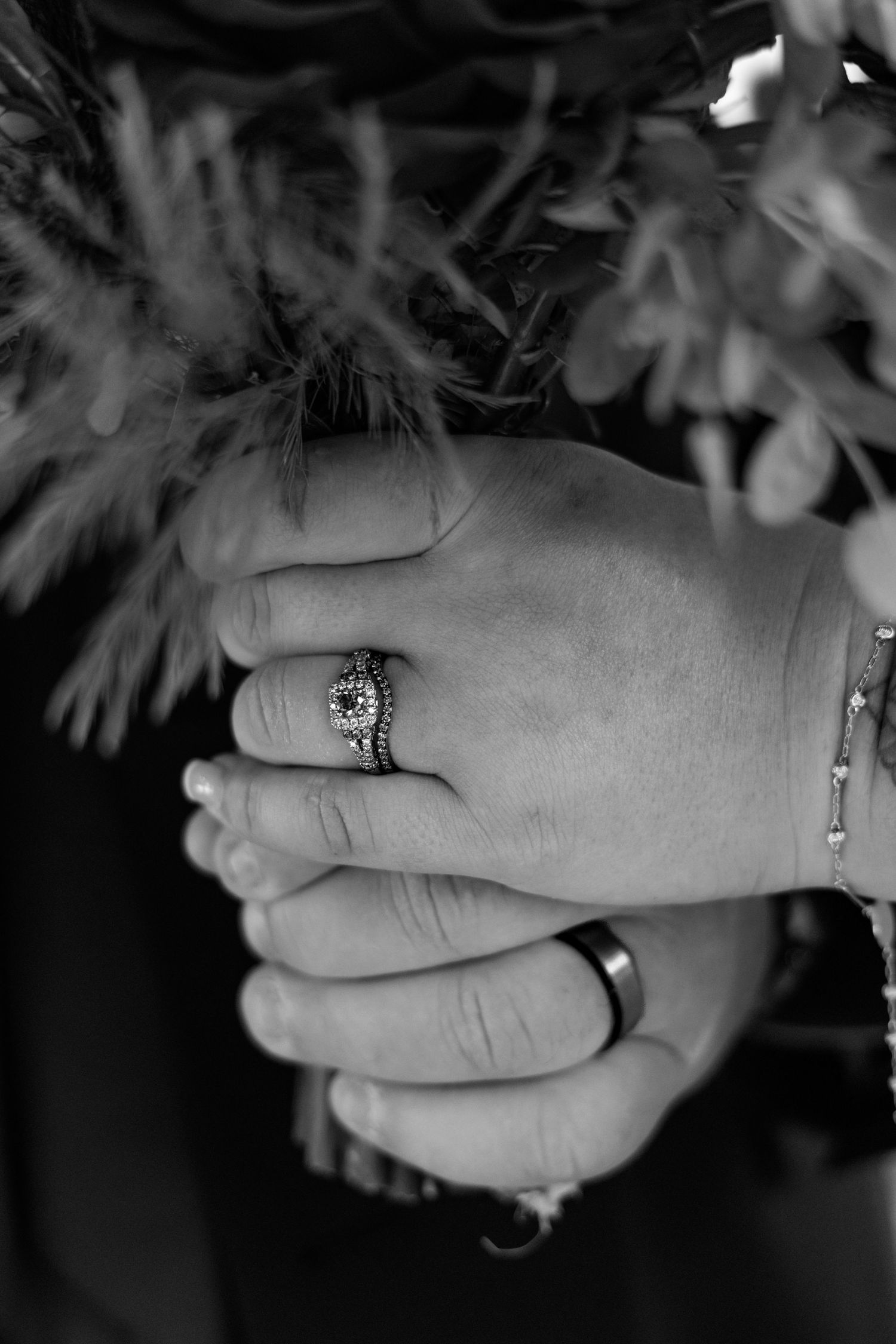 Black and white detail shots of wedding rings and hands.