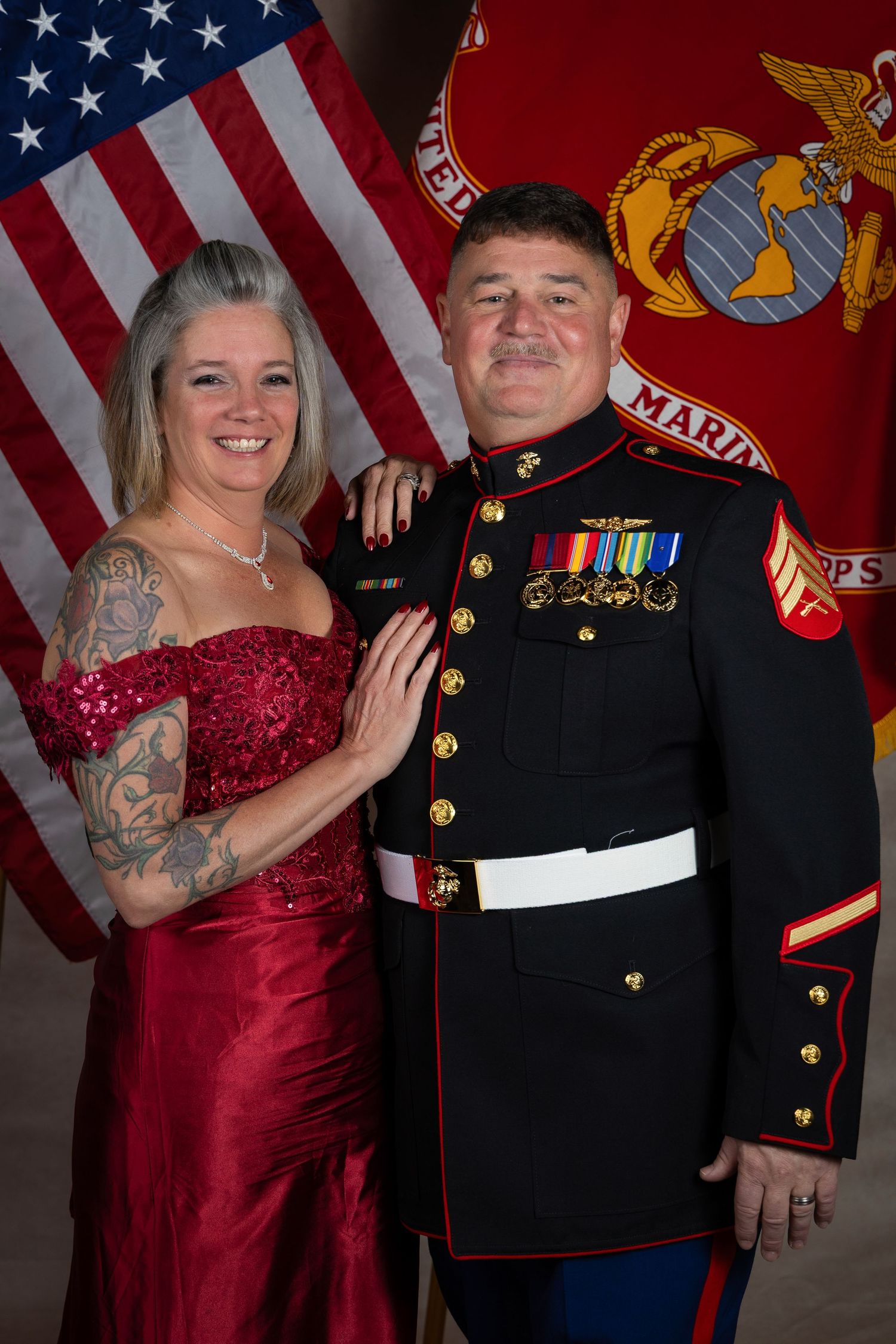 Formal portraits with Marine dress uniforms against military flag backdrop.