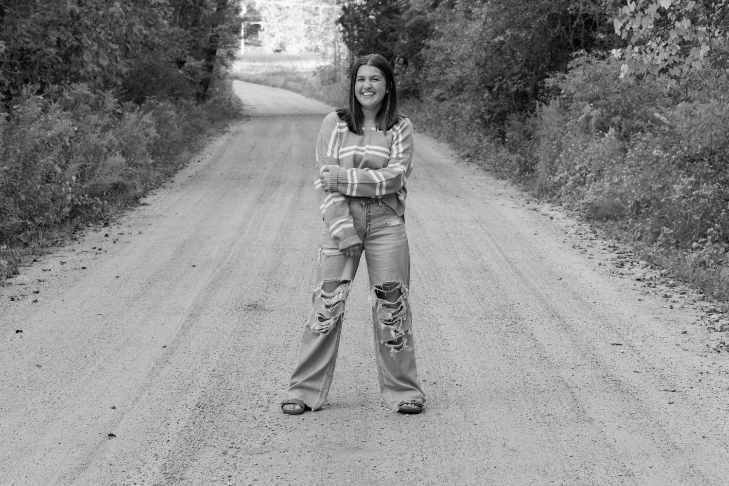 A series of candid poses on a rural dirt road surrounded by greenery and trees.