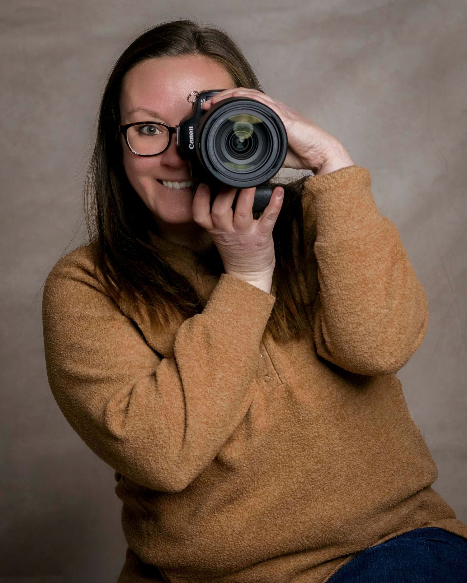 Series of shots showing photographer with camera wearing brown sweater against neutral background.