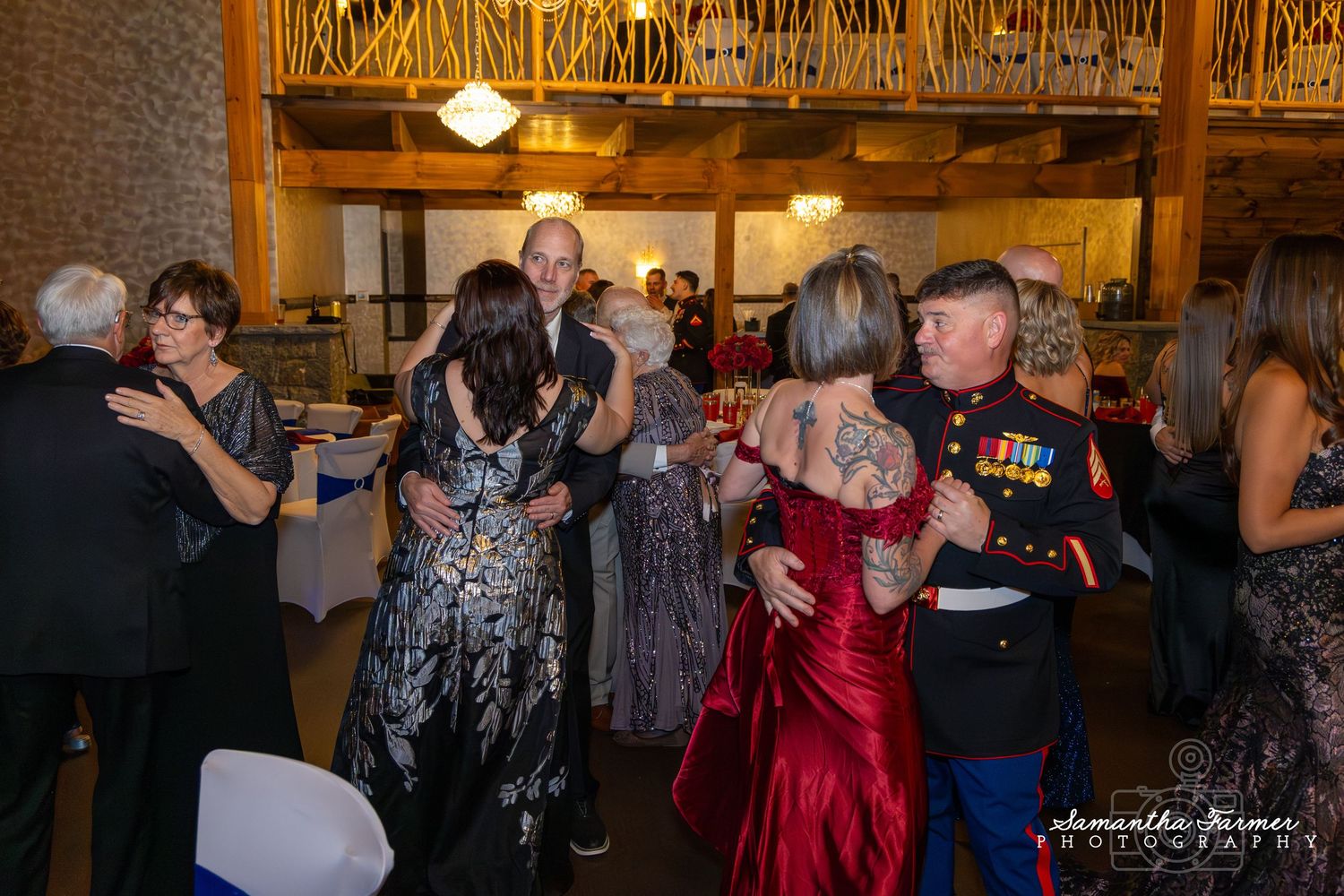 Military ball featuring couples dancing in formal attire and dress uniforms.