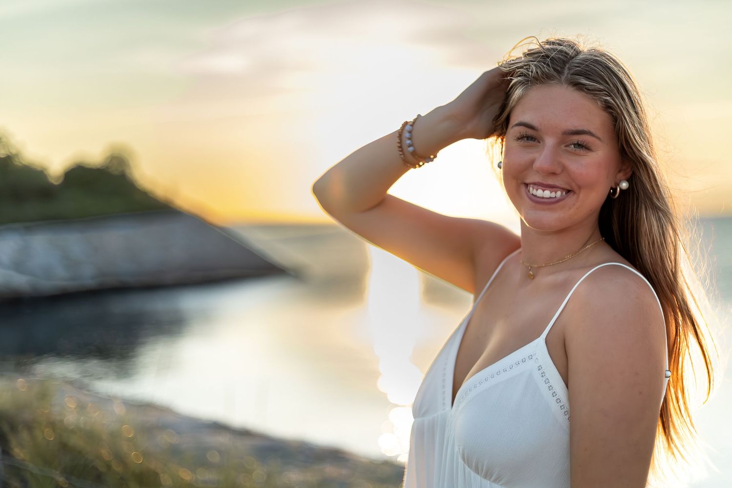Sunset beach photoshoot with golden hour lighting and water views.