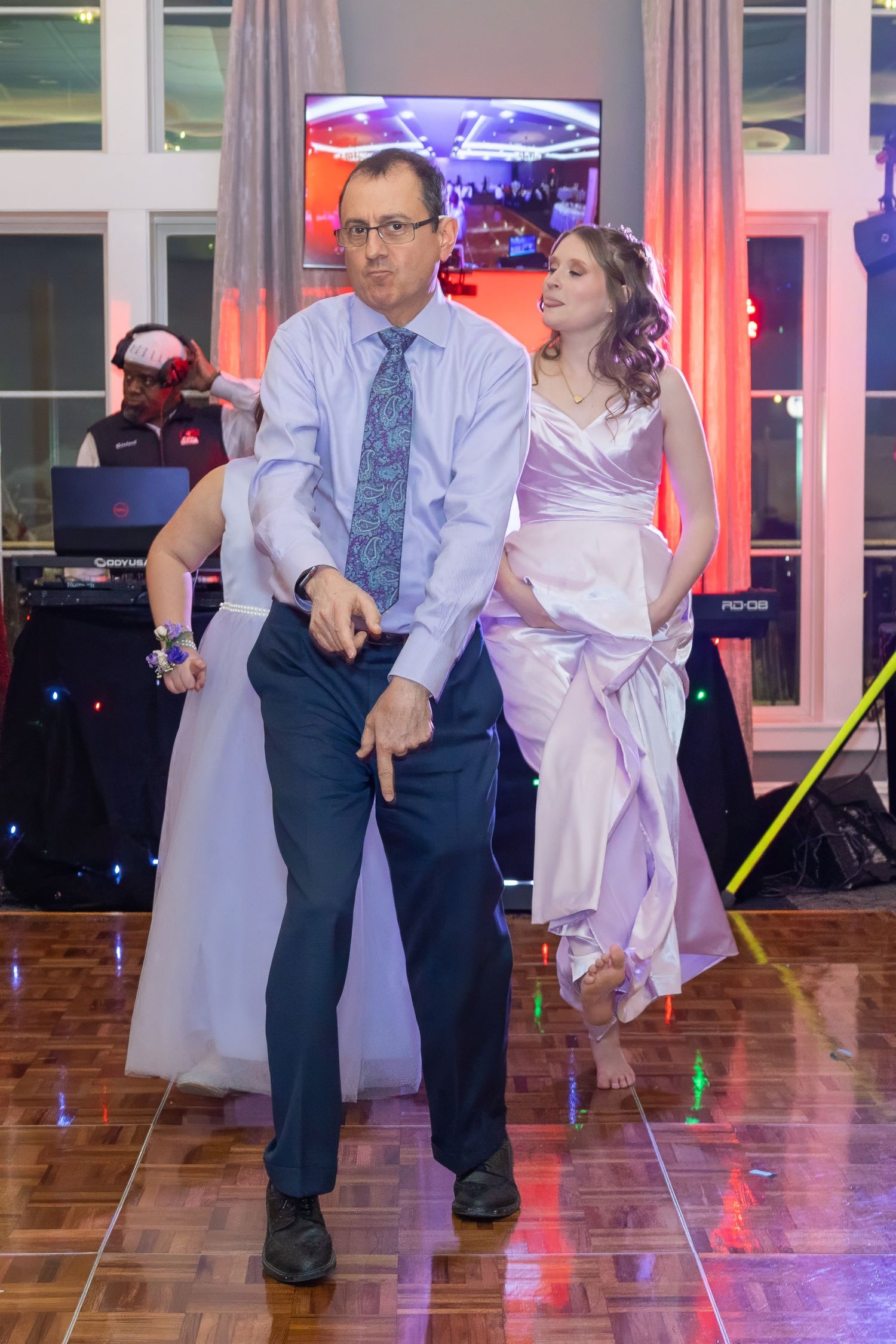 Dance performance with light-up props on a polished ballroom floor.