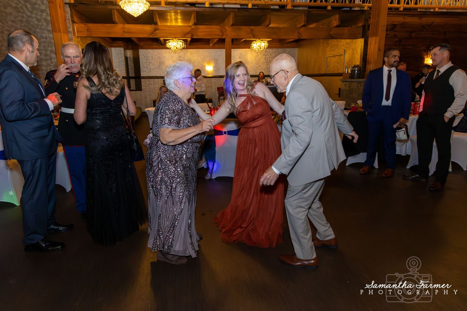 Couples dancing at a formal military ball in an elegantly lit venue.
