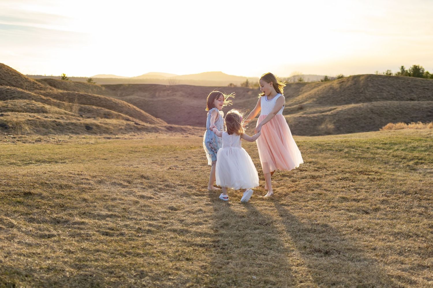 Sunset photography session in rolling hills with golden hour lighting.