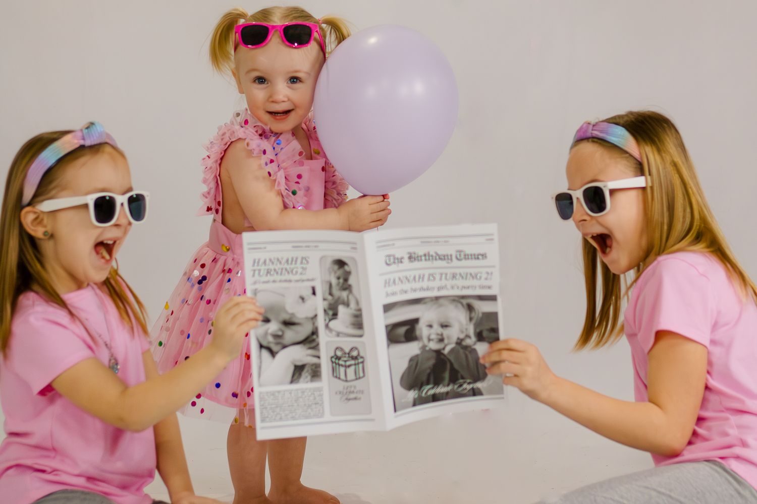 Birthday photo series with pink sunglasses and balloon props against grey backdrop.
