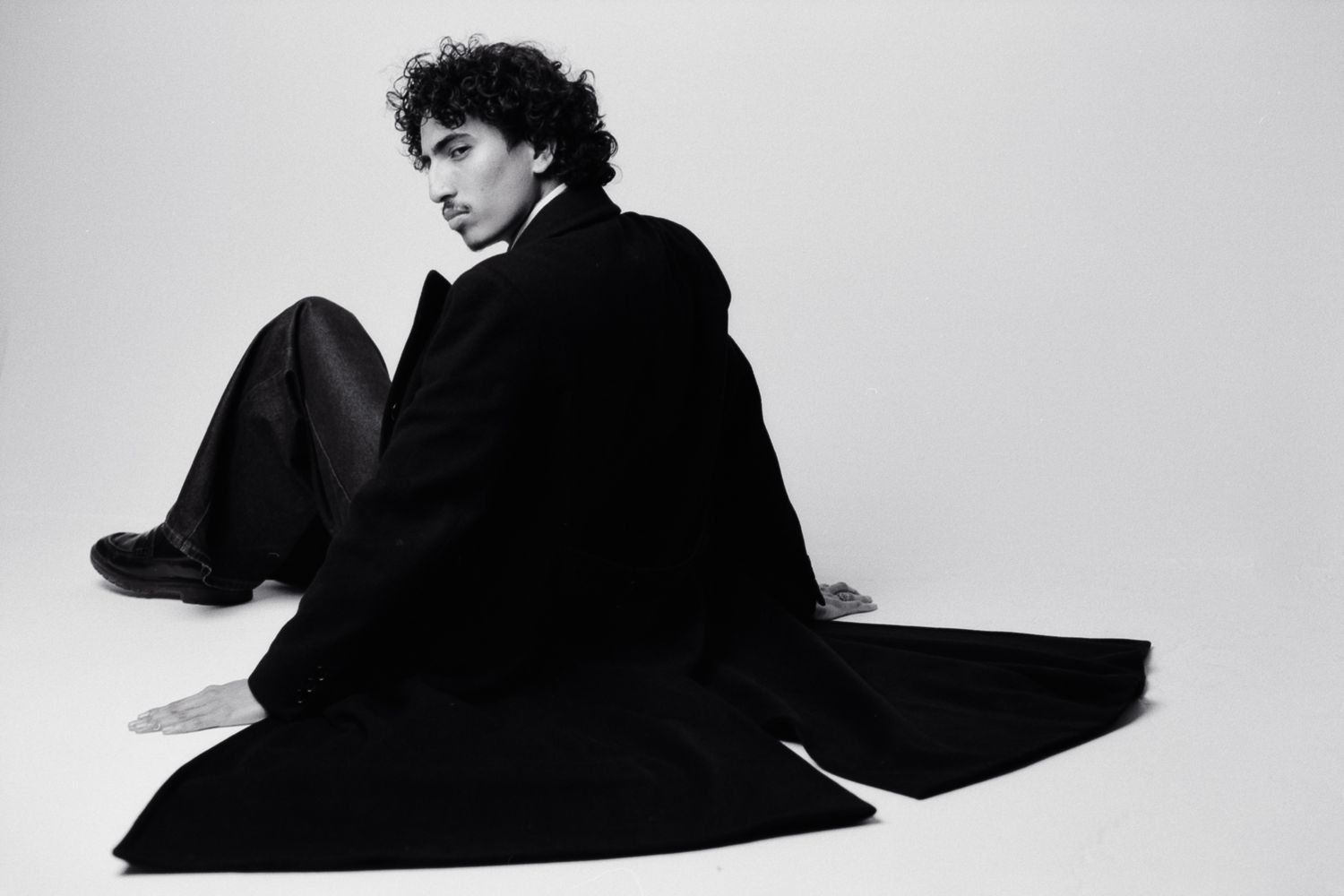 Artistic black and white portrait series showing dramatic shadows and poses against white background.