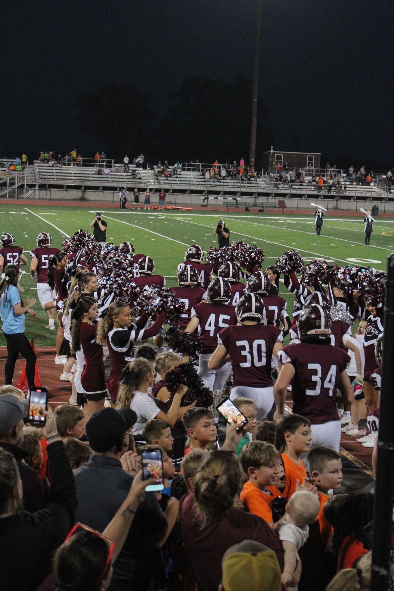 Oskaloosa HS Football players running to the game taken by Kaelan Knudtson