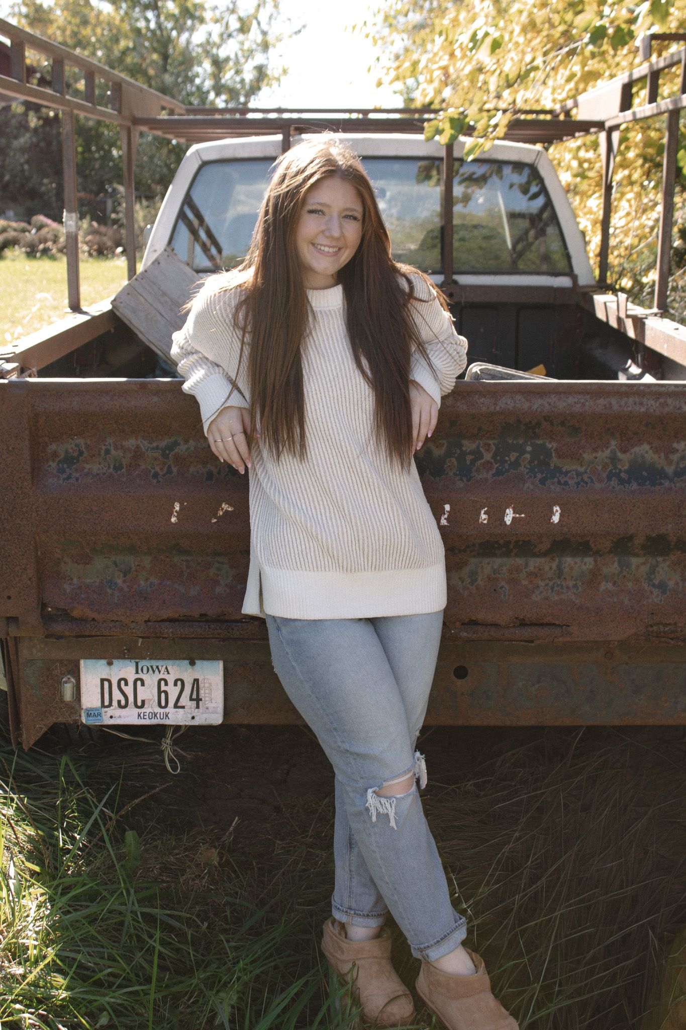 Sidney Thompson posed by a rustic truck, Taken by Kaelan Knudtson