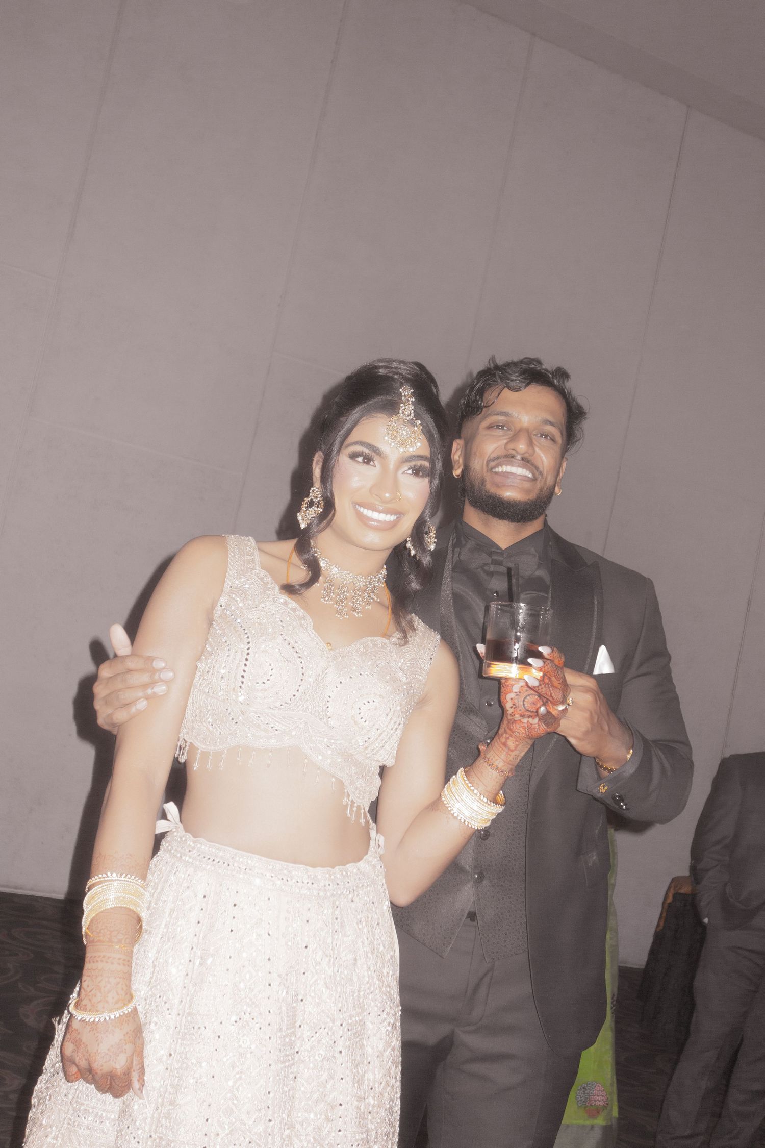 Couple in matching formal wear smiling and posing together at a special event.