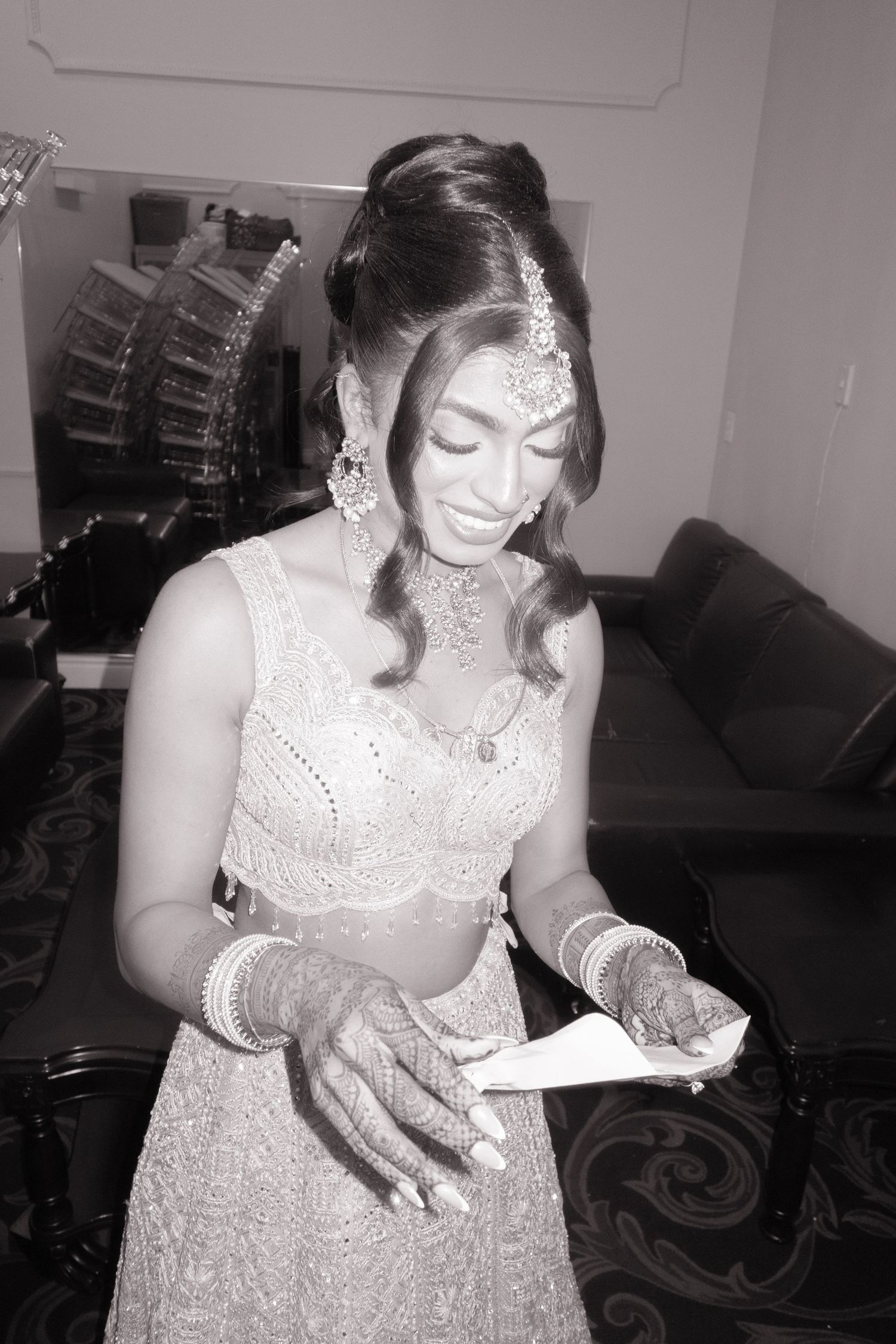 Woman in traditional Indian-inspired formal wear reading a document.