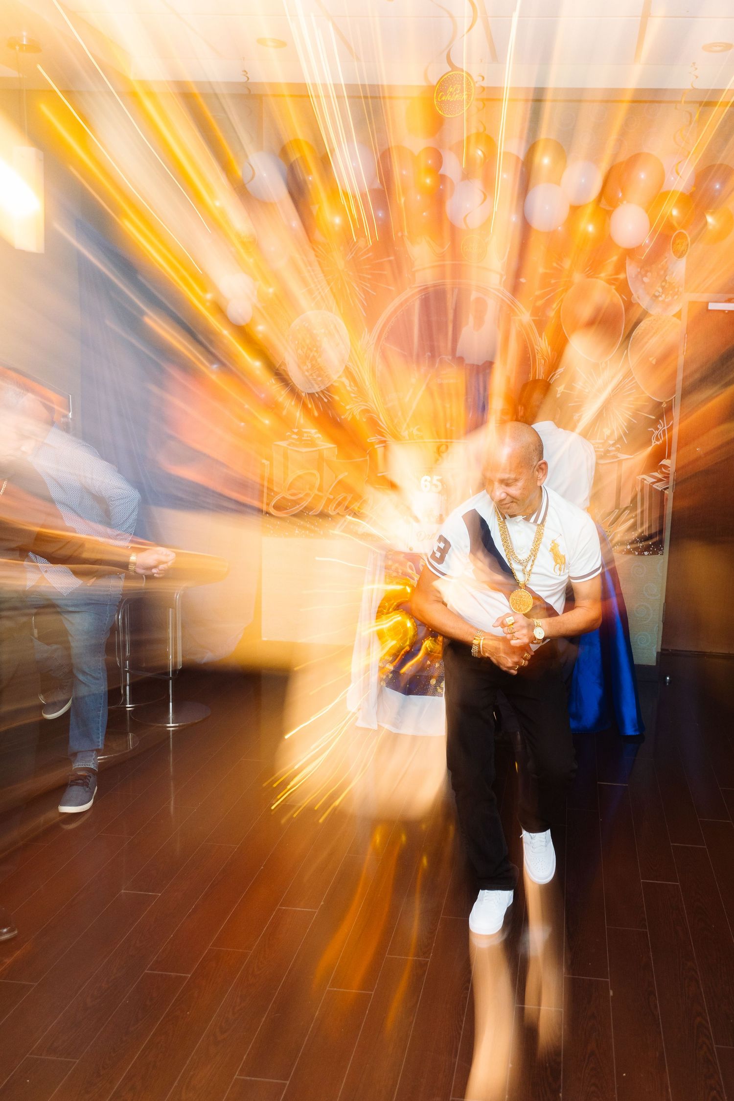 Dynamic motion blur photo of dancing at a party with golden light streaks.