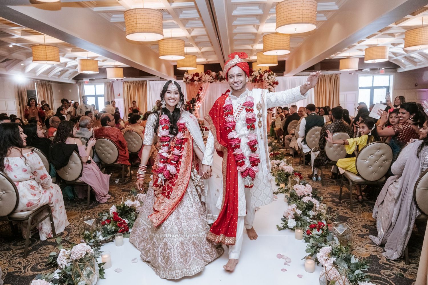 Indian bride and groom walking together down the aisle after their traditional Hindu wedding ceremony.