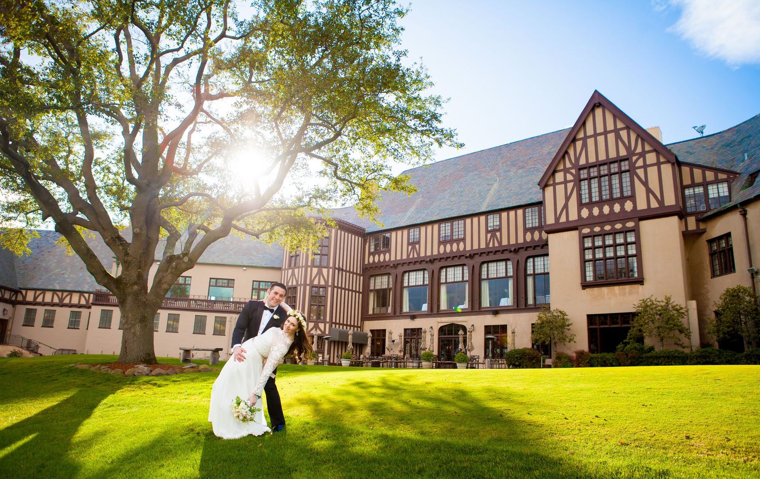 Panoramic sequence of a rustic Tudor-style wedding venue with manicured lawns and sunlit trees throughout the day.