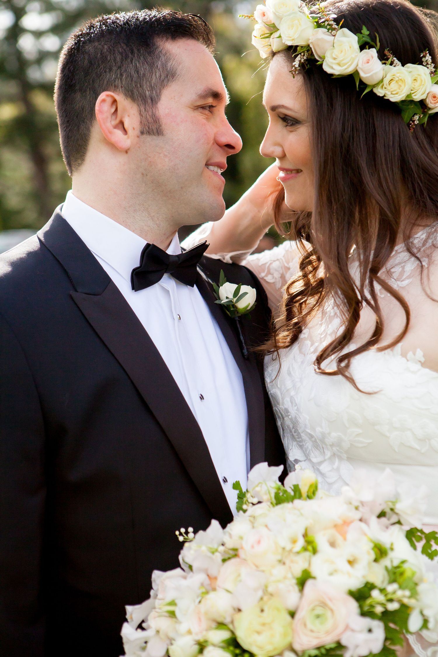 A romantic wedding photo series showing close-up moments between newlyweds with white and pink floral bouquets.