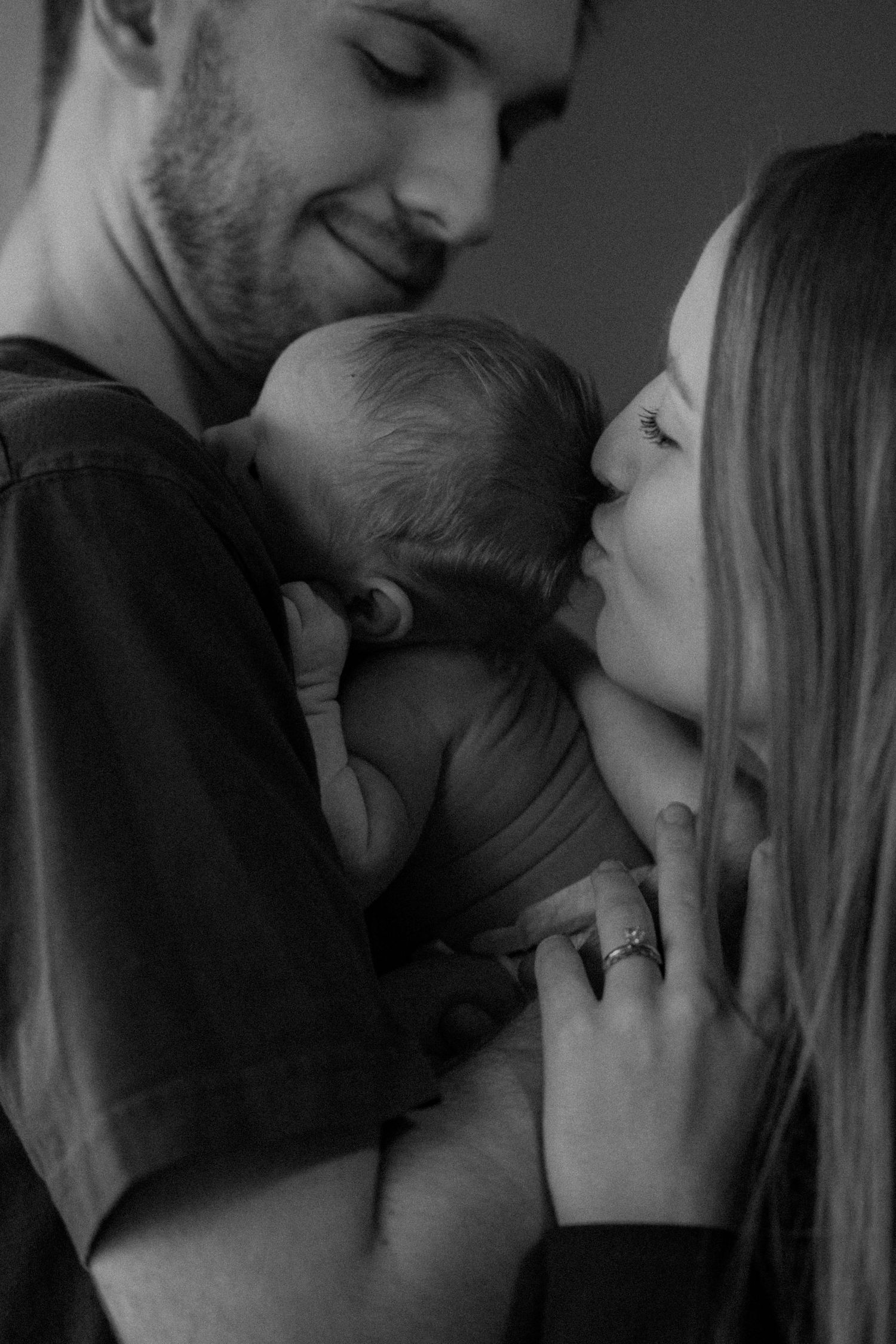 A romantic black and white photo sequence showing an intimate couple sharing tender kisses and embraces.