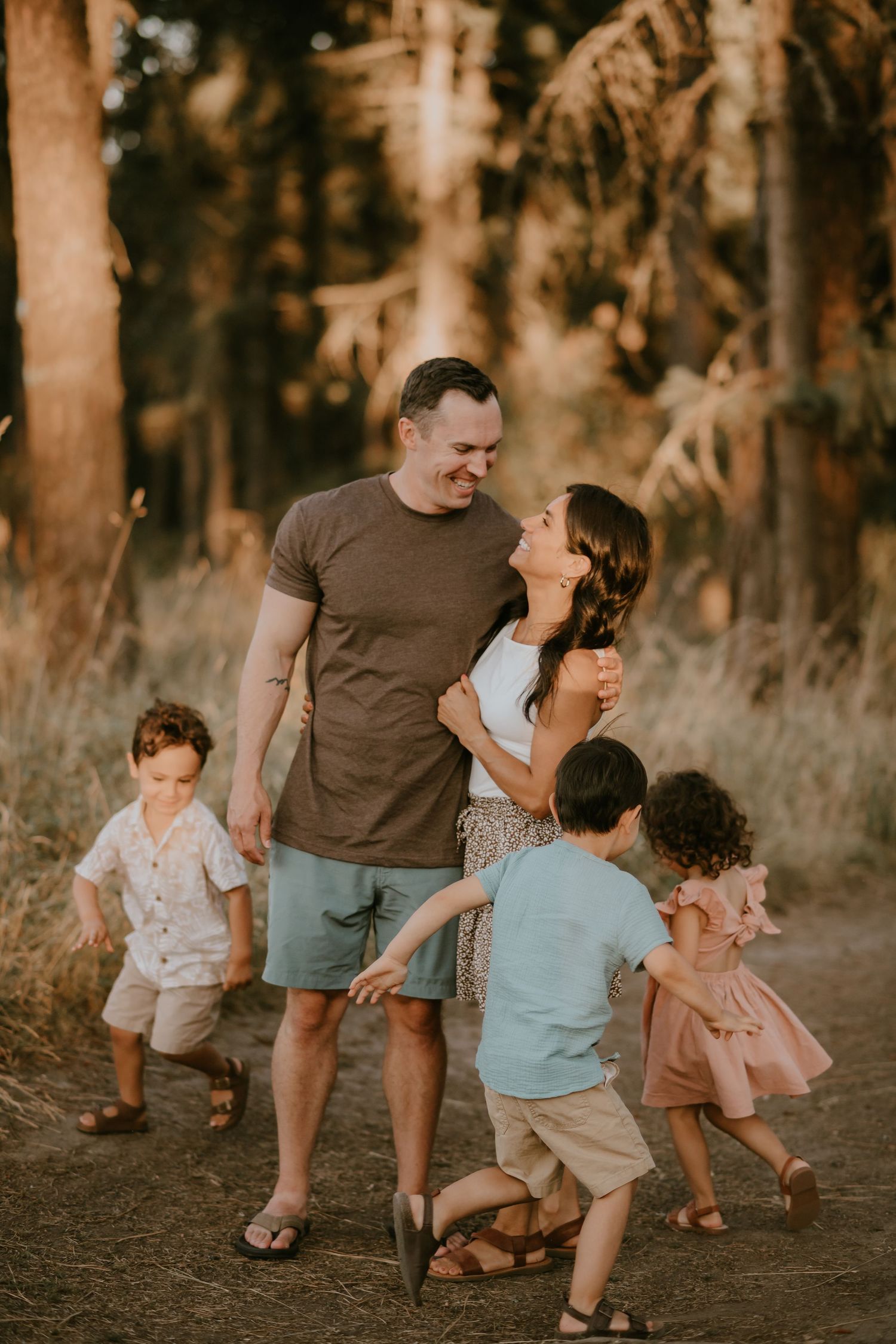 A candid series of photos showing a family walking together through a wooded area at sunset.