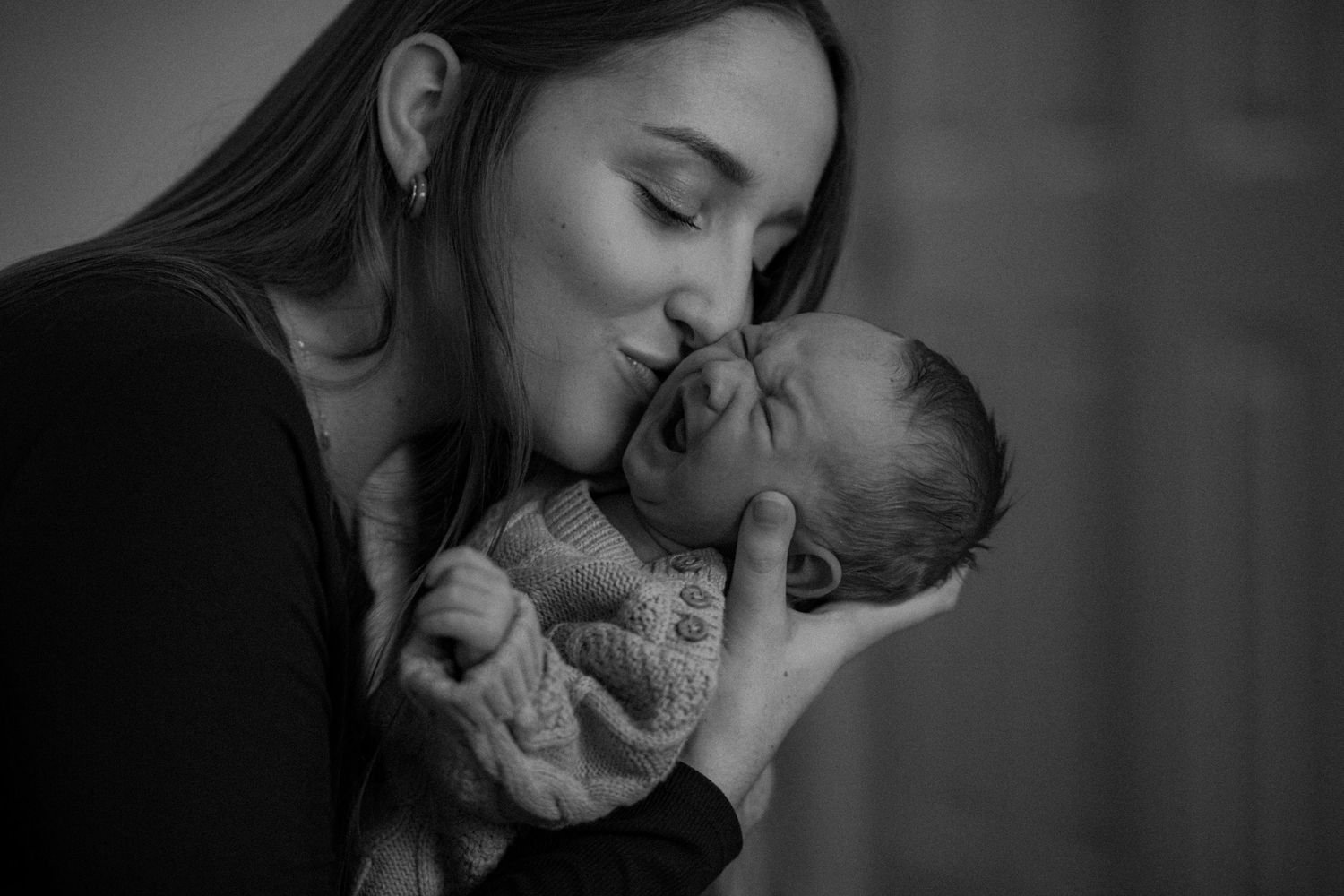 Black and white series of intimate candid moments shared between couple during romantic engagement or wedding shoot.