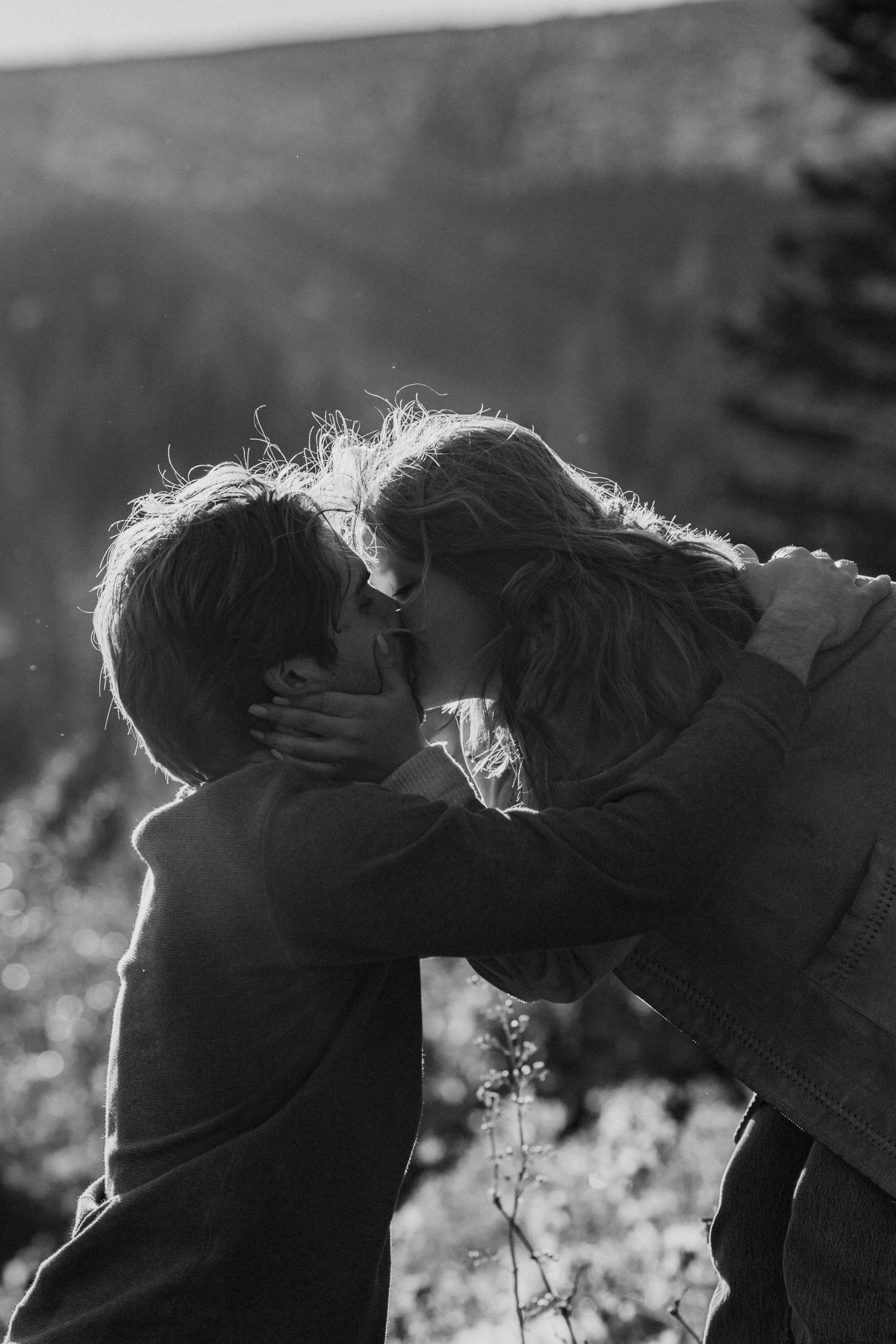A series of silhouettes showing two people embracing in backlit scenes with a dreamy, romantic atmosphere.