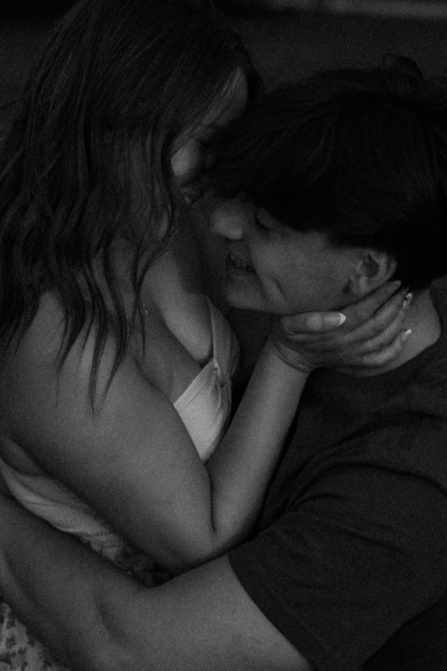 A black and white photo series showing intimate close-up shots of a couple sharing tender moments together.