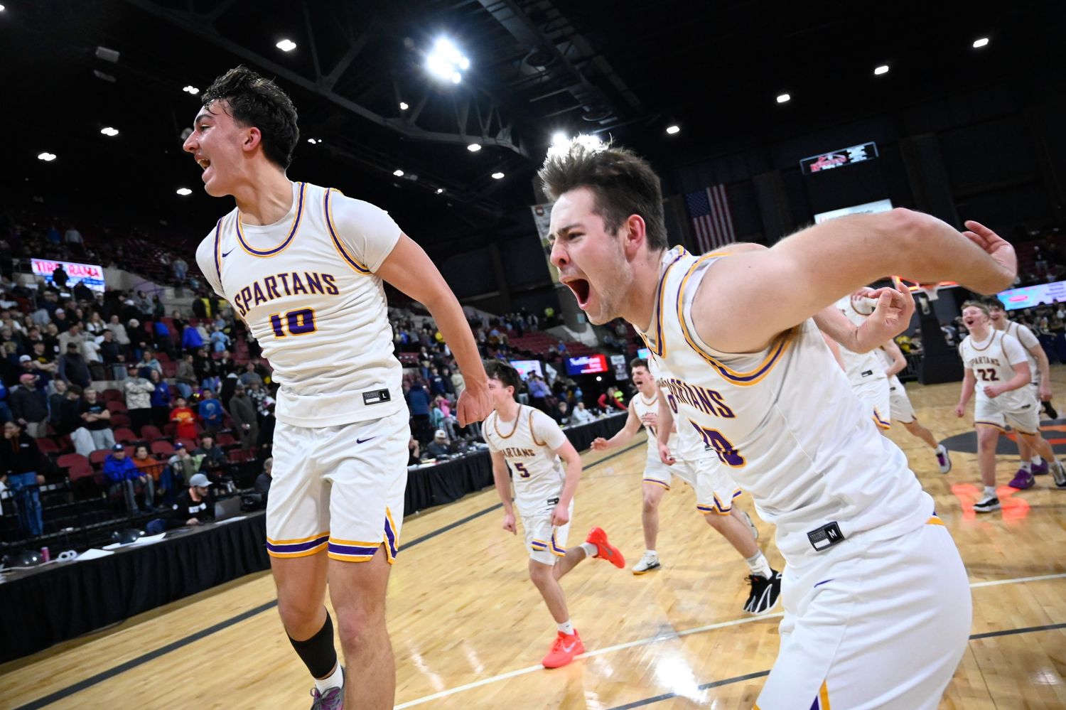 Kade Robinson (left) and Stellan Ridley (right) celebrate on the court after defeating Billings West High in overtime 47-46 for the champion