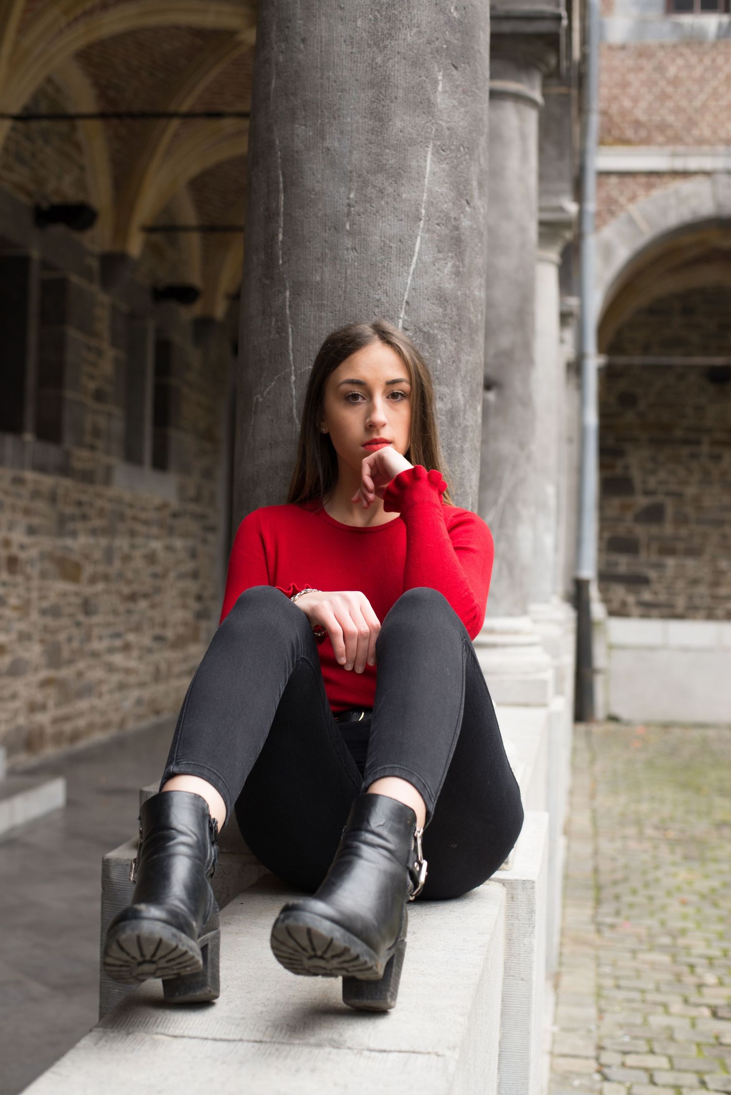 À Liège, au musée de la Vie wallonne, portrait d’une femme assise sur un muret lors d’une séance photo urbaine