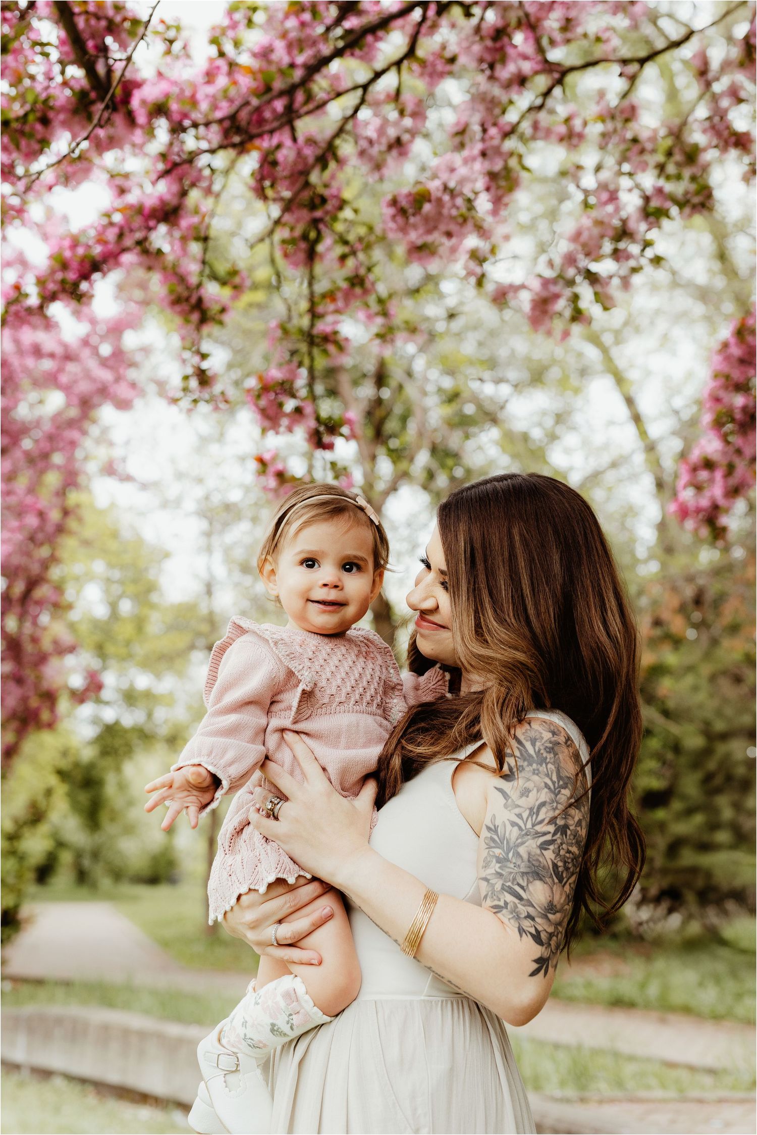 mother and children walking under blossom trees Edmonton family photography