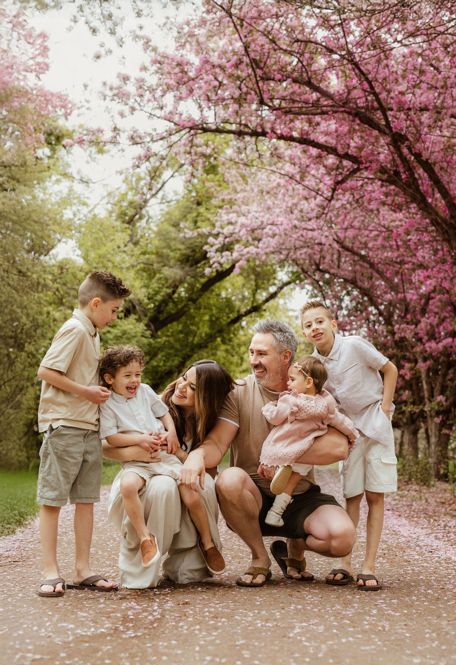 Edmonton family photographer spring blossom session with family under blooming trees