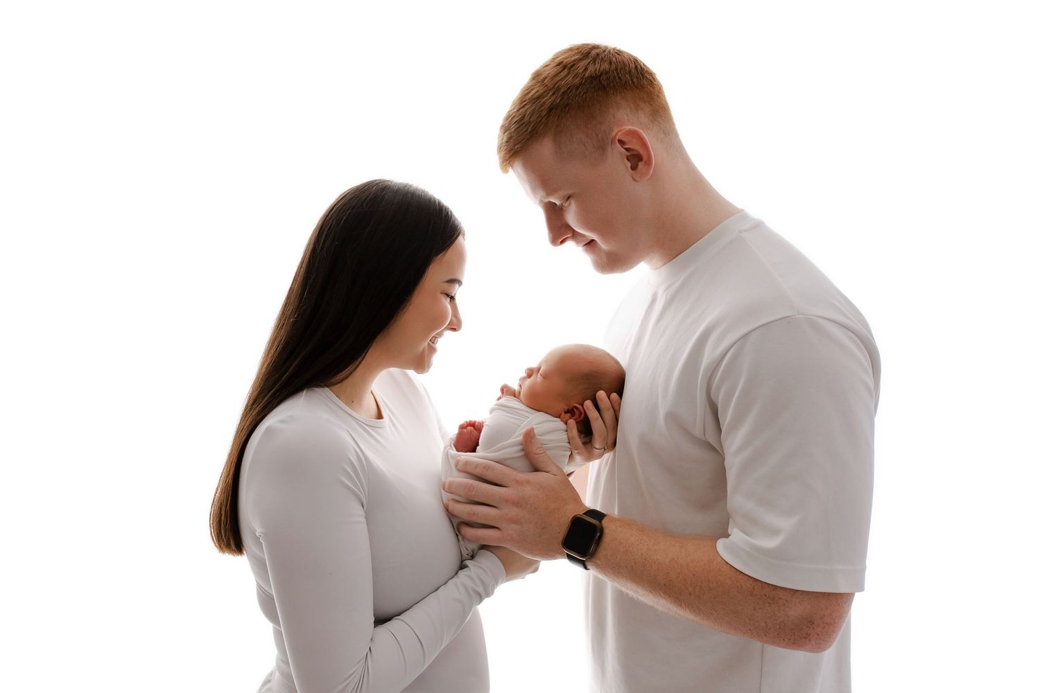 Adelaide newborn family photo on clean white background by Lin Photography - parents lovingly holding sleeping baby