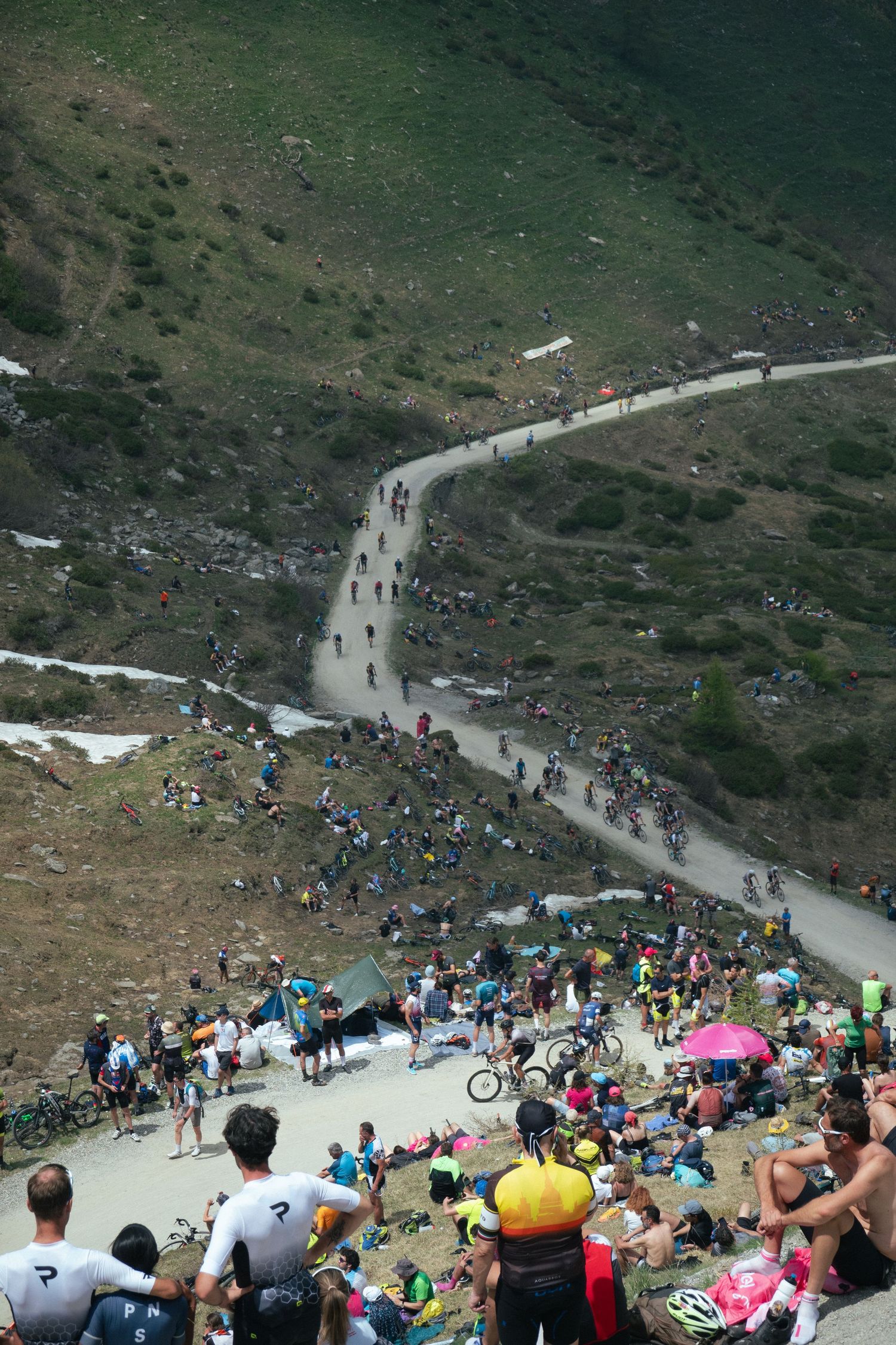 Spectators line a steep mountain road Colle delle Finestre to watch cyclists during Giro d'Italia