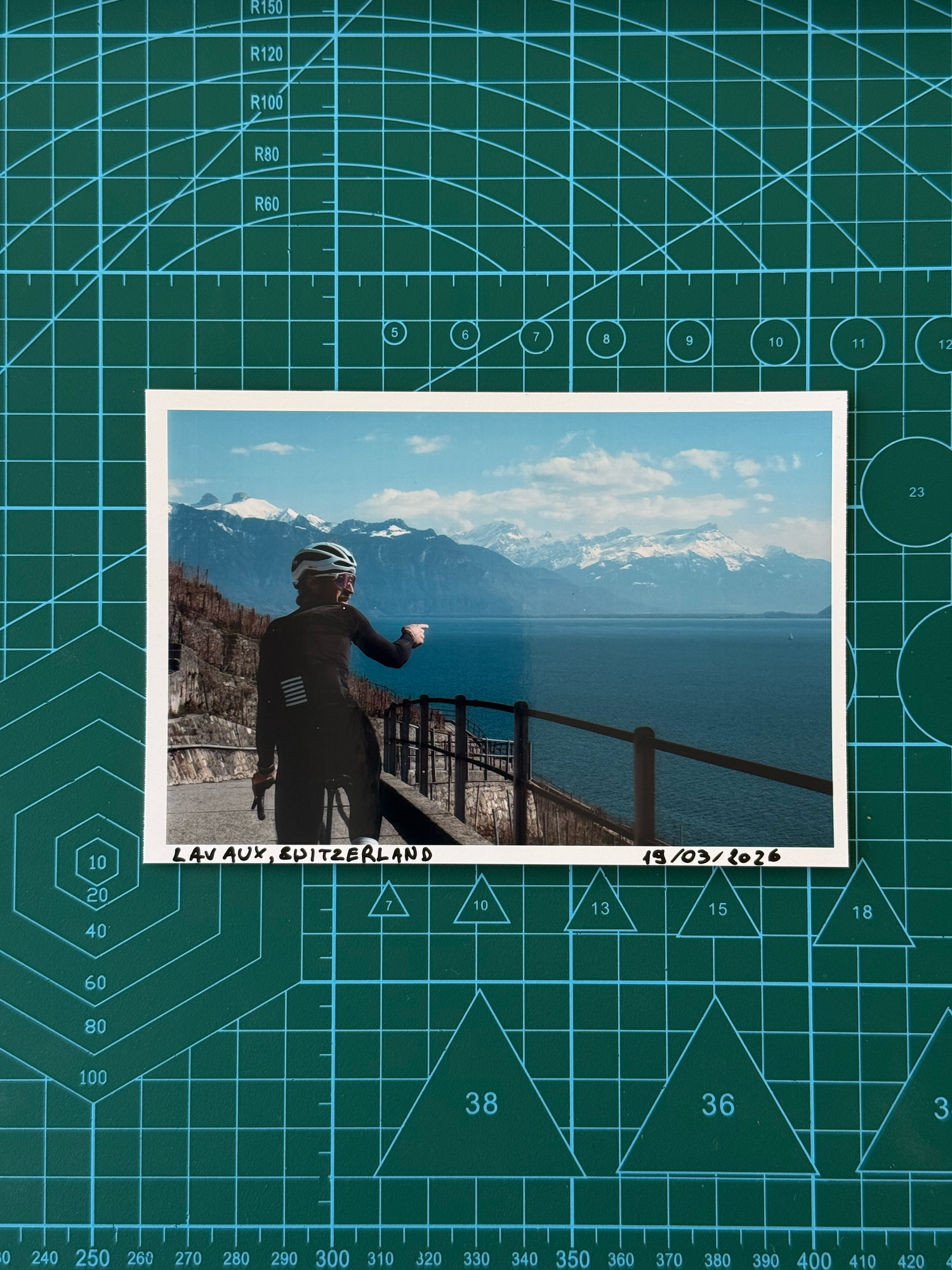 A series of panoramic mountain landscape photos displayed on a green cutting mat background with measurement grid lines.