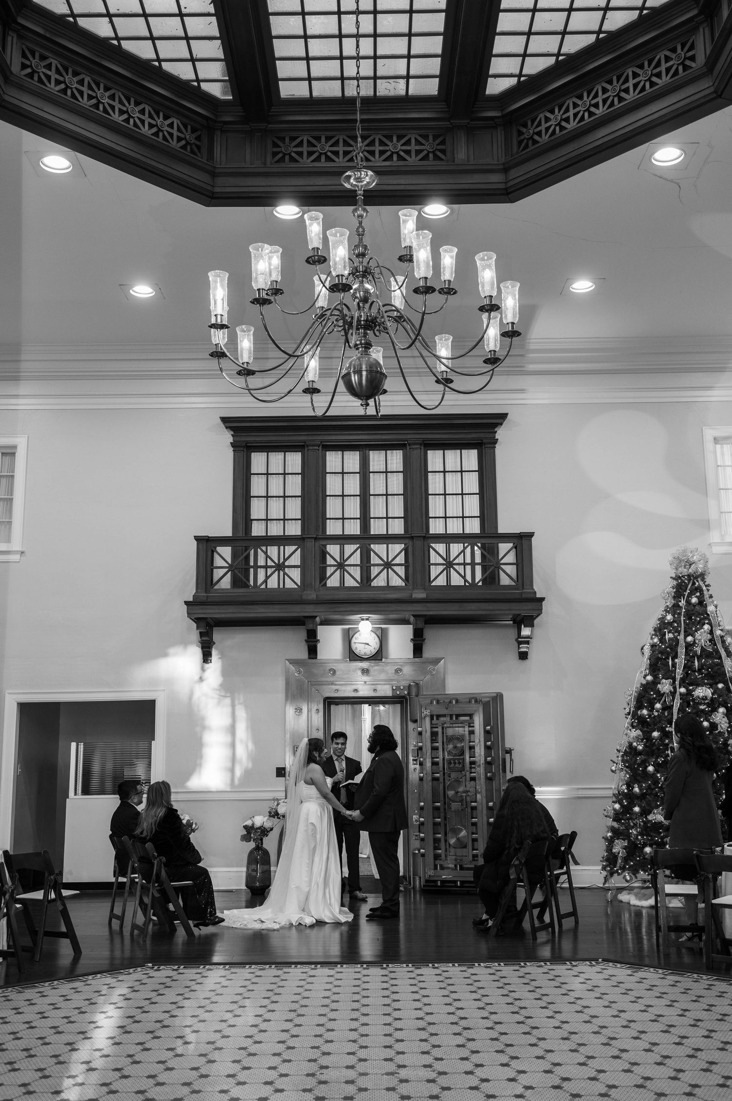 Bride and groom standing together hand in hand while exchanging their vows.