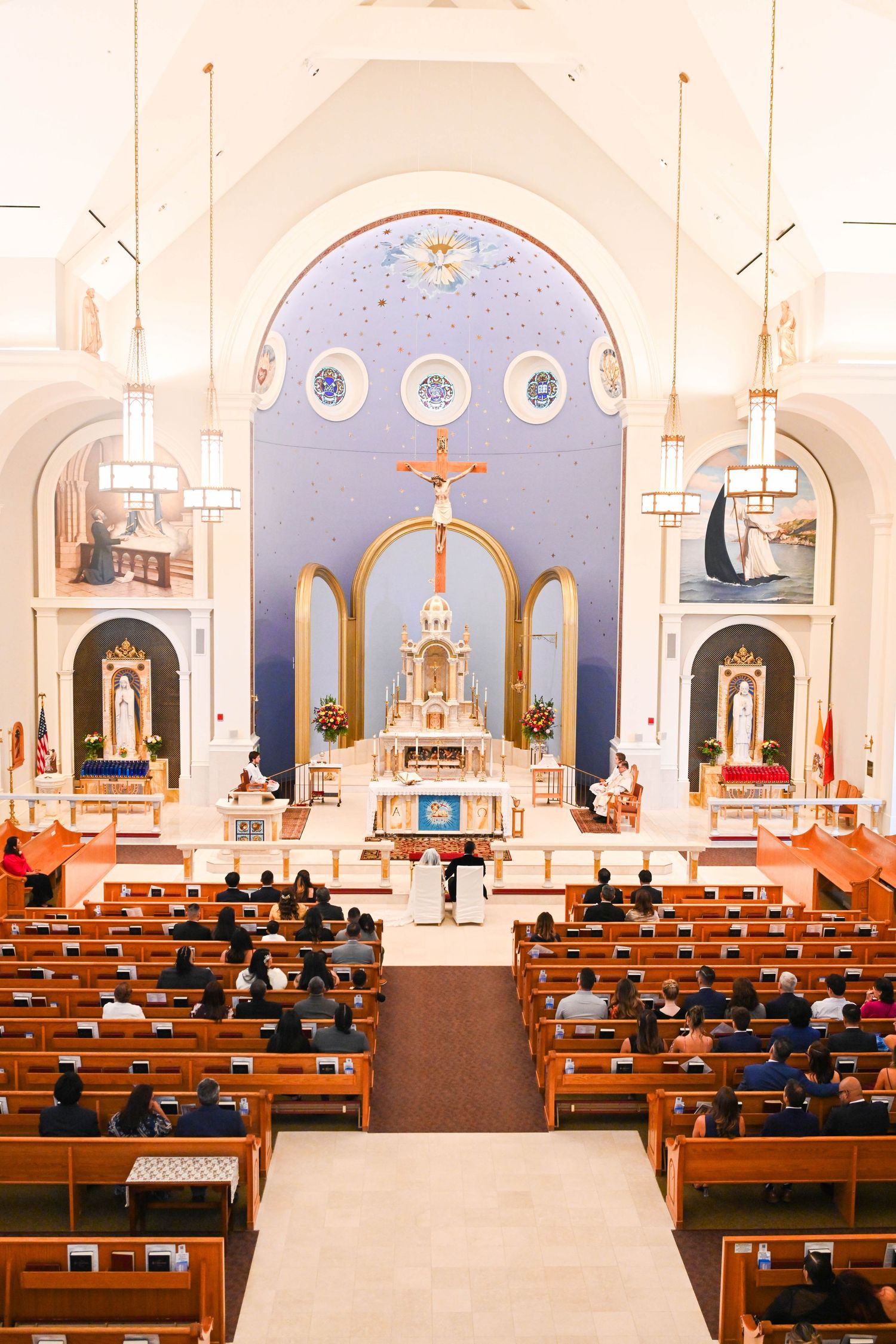Couple exchanging vows during a beautiful Catholic church wedding ceremony.