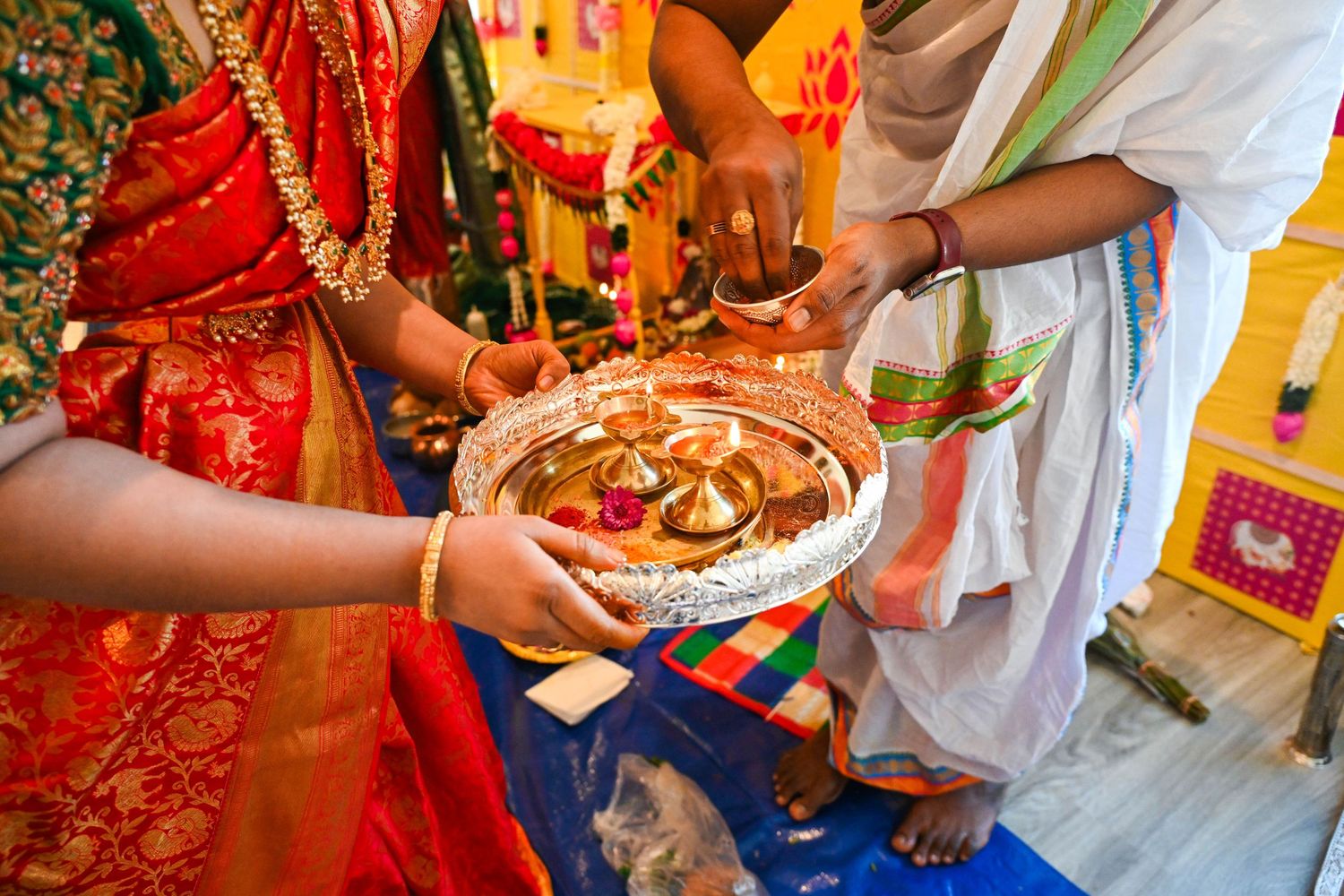 Elegant portrait of the women holding incense together while showing off their dresses and jewelry.