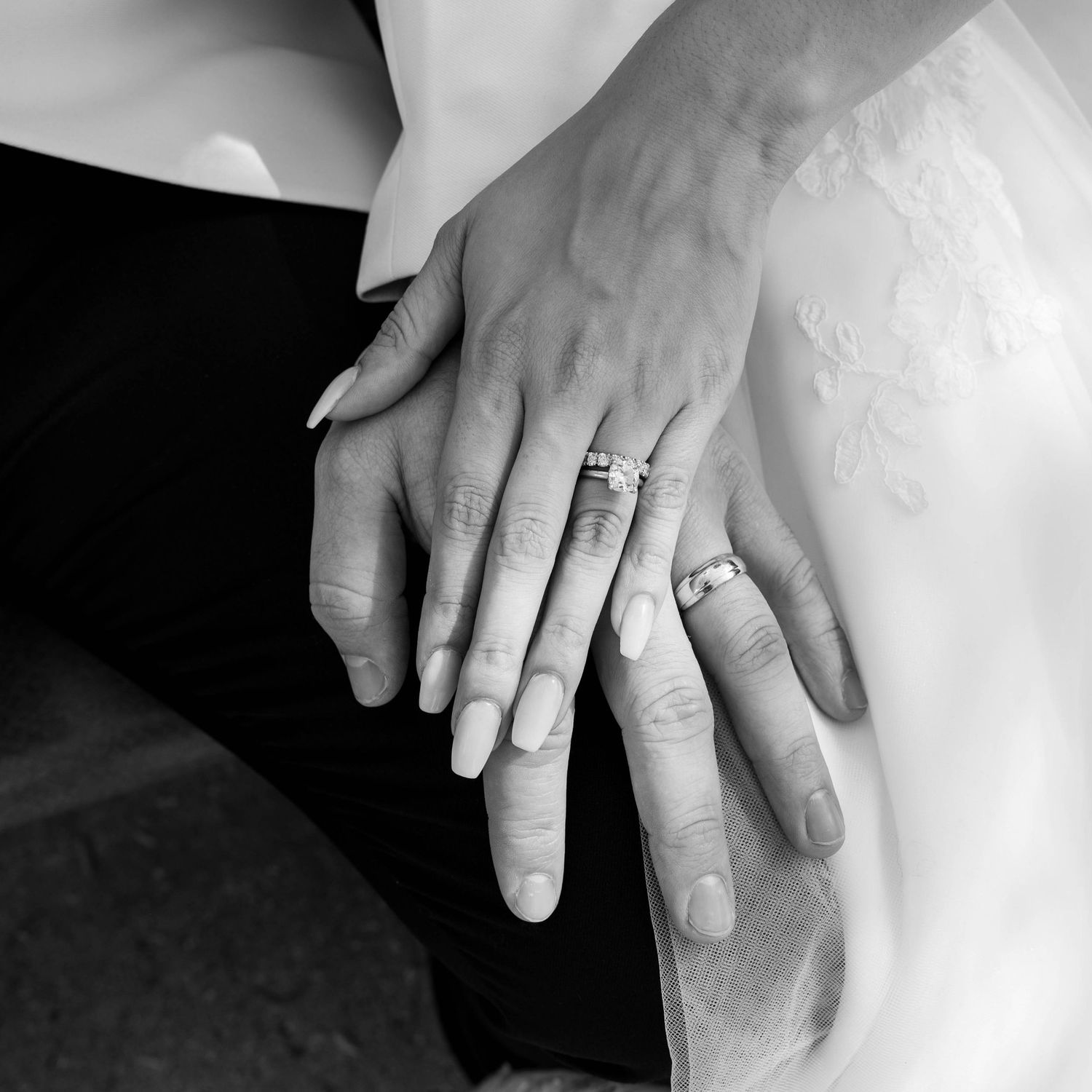 Bride and groom hand-holding portraits showcasing wedding bands and authentic connection.