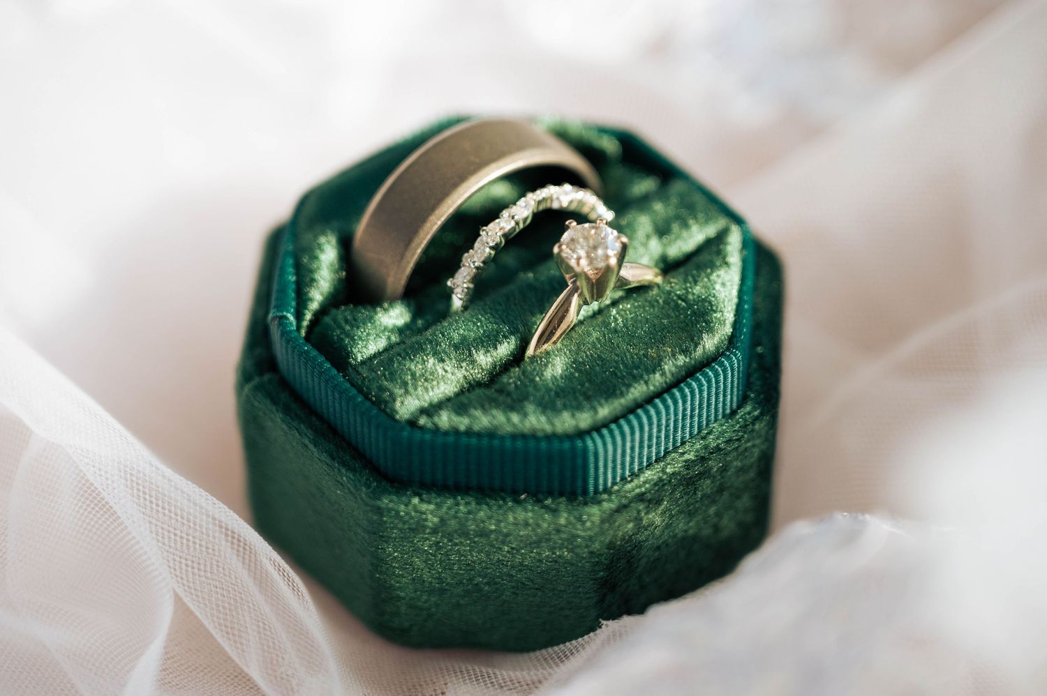 Elegant wedding ring box featuring the couple’s wedding bands in detail.