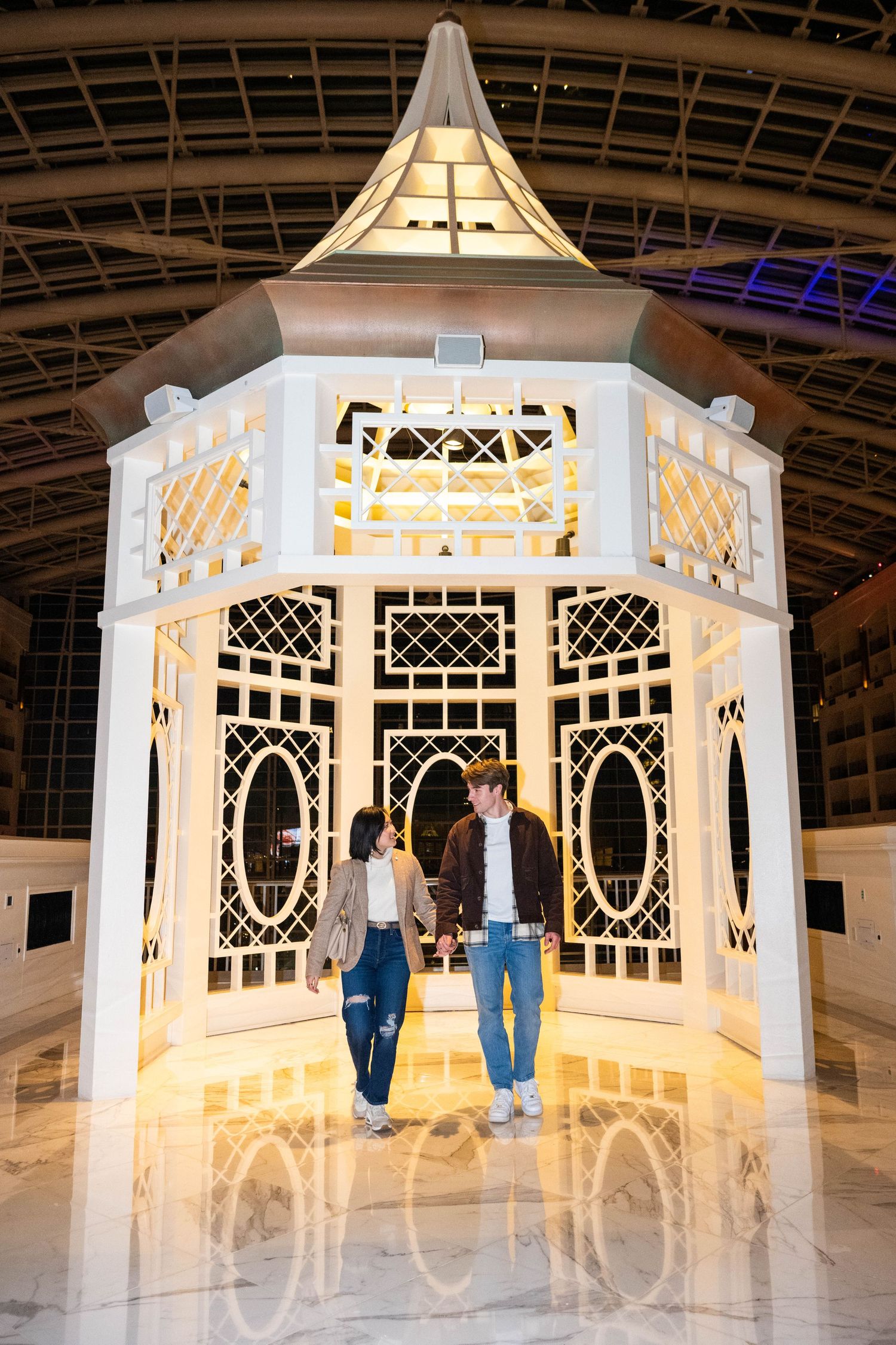 Romantic portrait of a couple walking together inside the Gaylord National Resort & Convention Center.