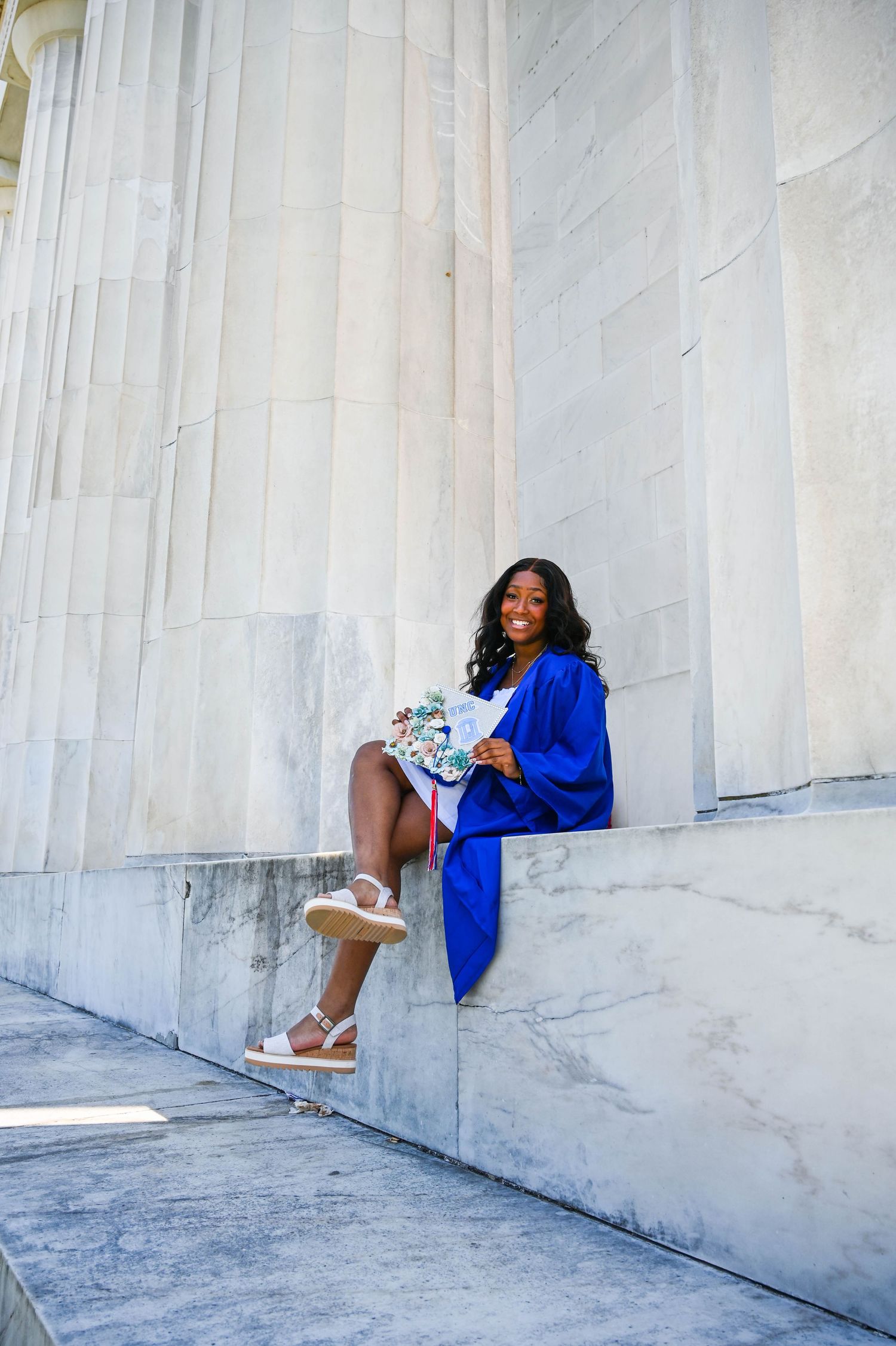 Graduation portraits sitting on the steps of the Lincoln Memorial with a timeless and iconic backdrop.