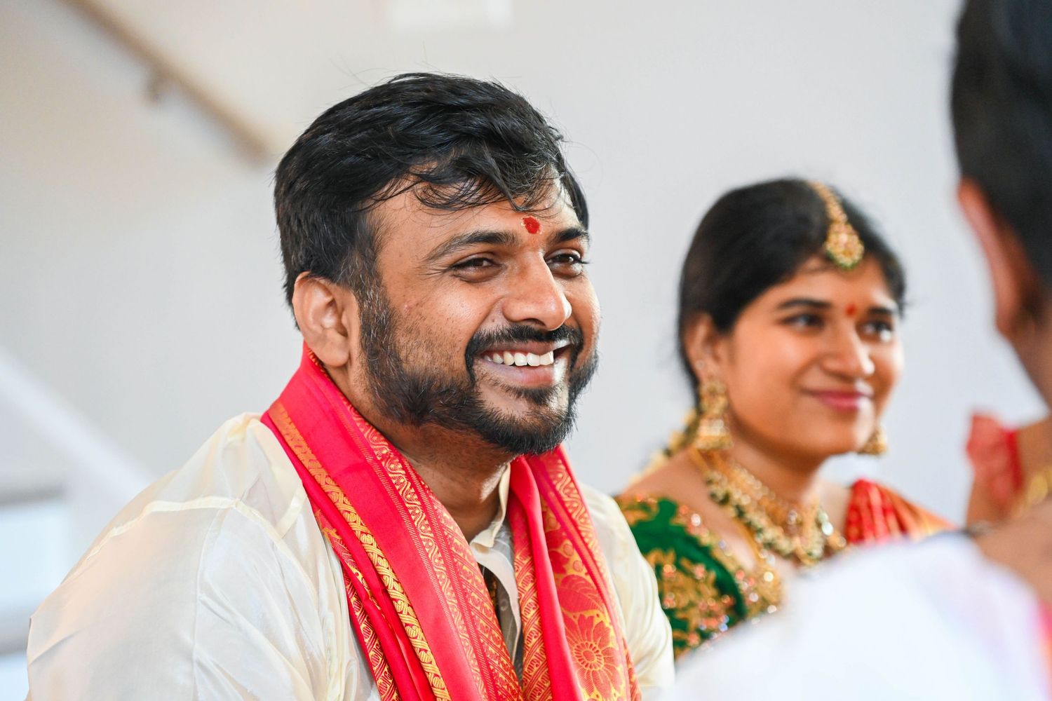 Husband smiling proudly toward the camera during the housewarming celebration.