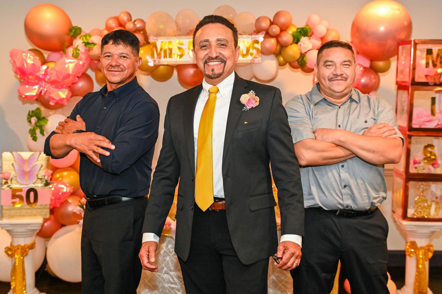 Fun and stylish photo of the husband posing with his brothers with their arms crossed.