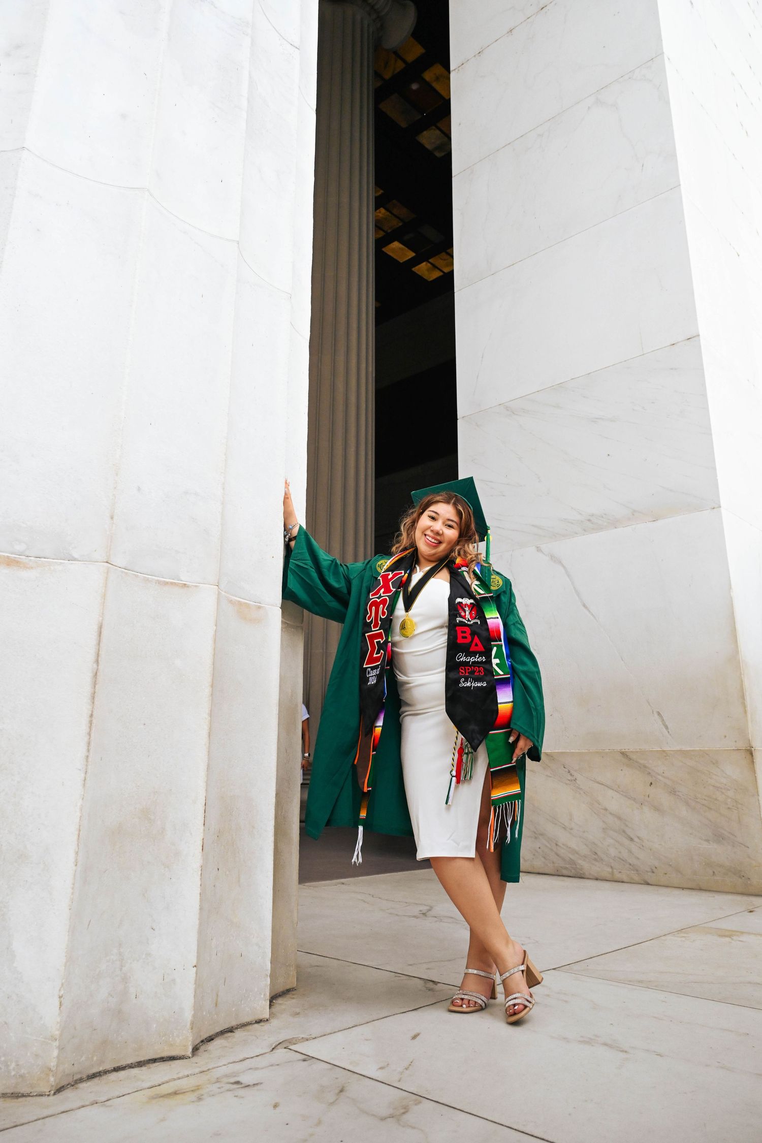 Graduation portraits at the Lincoln Memorial capturing confidence and accomplishment.