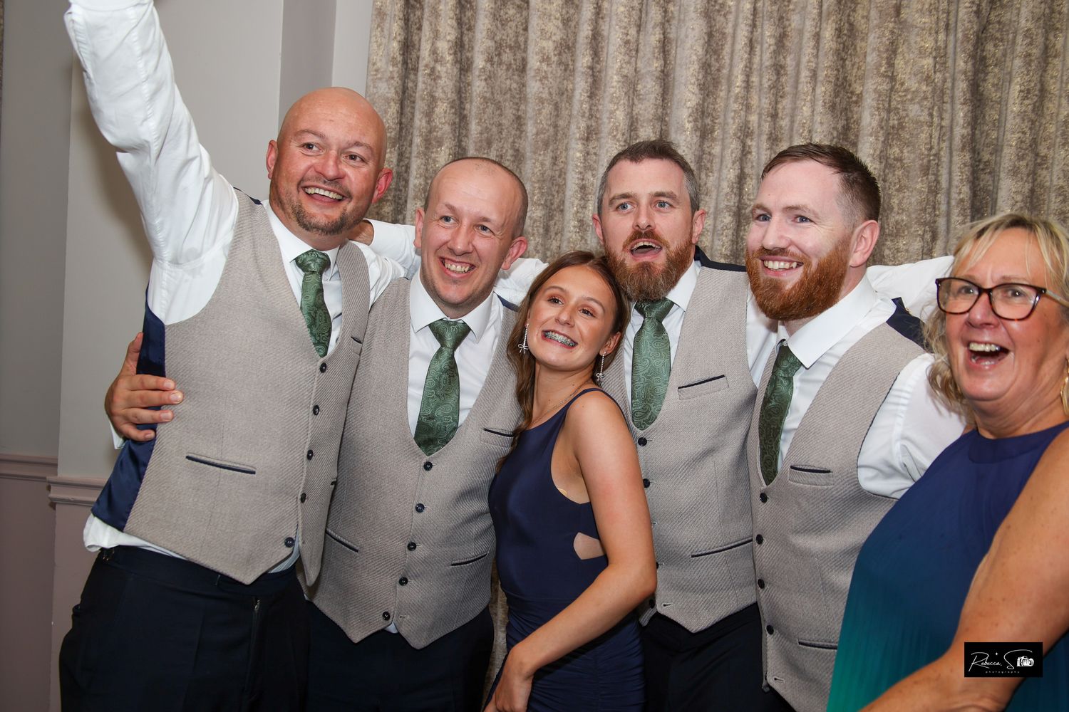 Wedding reception celebration with guests in formal attire enjoying festivities.