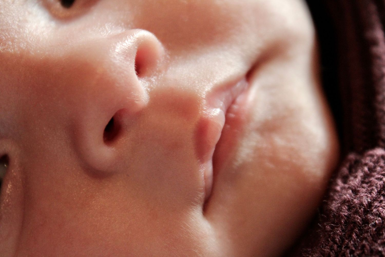 Extreme close-up of baby's facial features showing nose and mouth.
