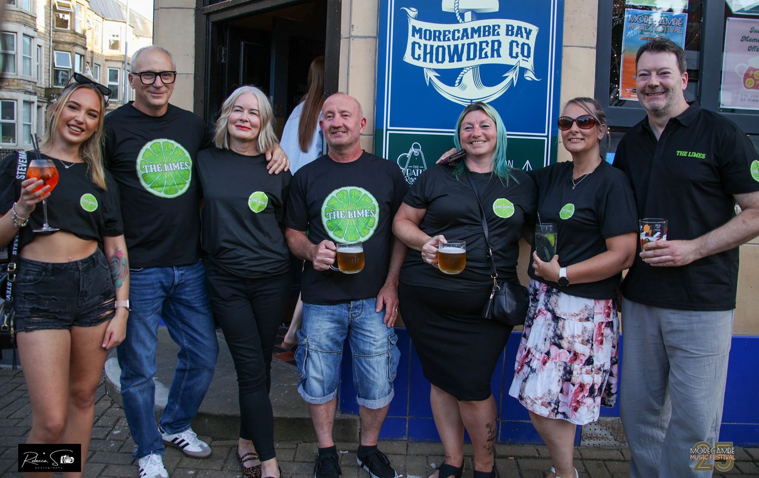 People wearing The limes logo shirts posing together outside pub entrance at the bath morecambe