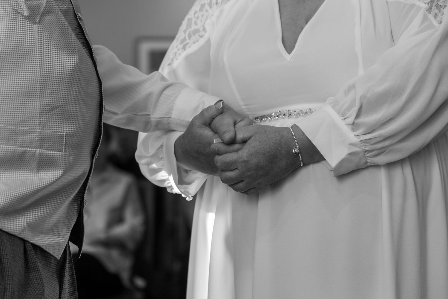 Close-up details of formal wedding attire in black and white.