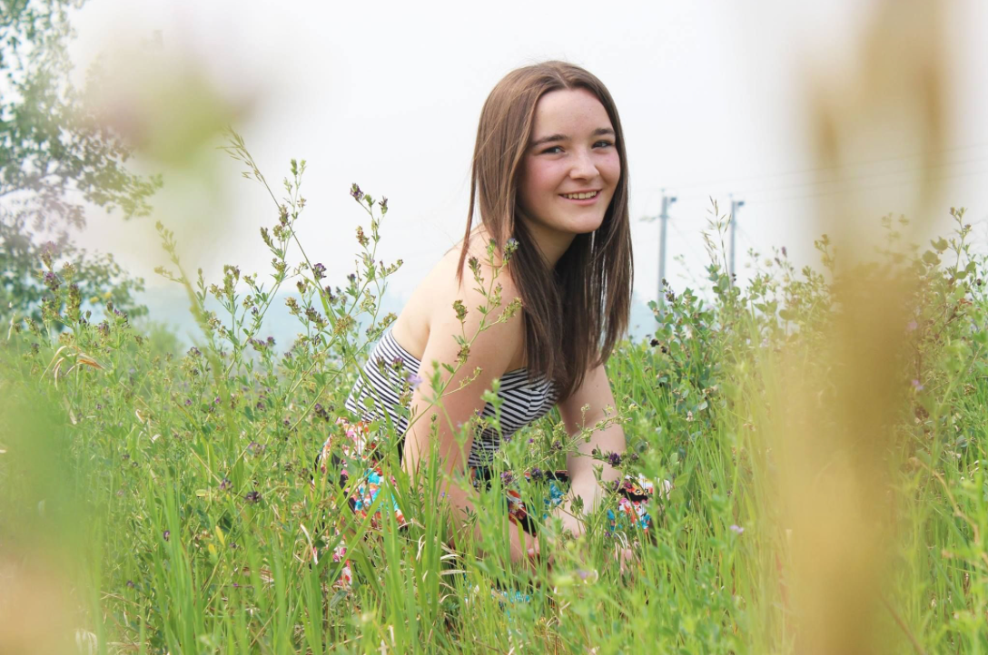 Soft focus portrait in a wildflower meadow with bokeh effect.