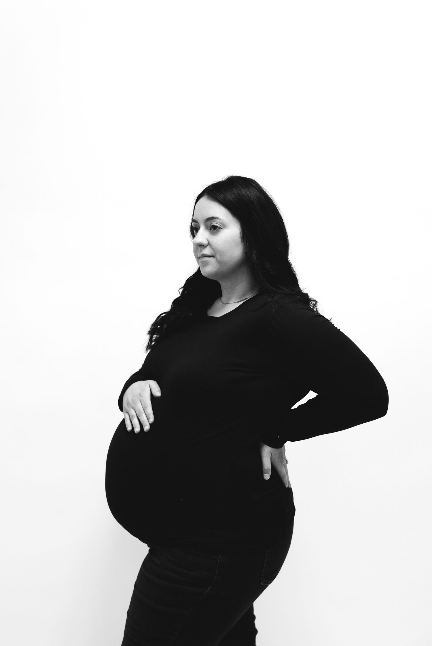 Black and white maternity photo of mom posing.