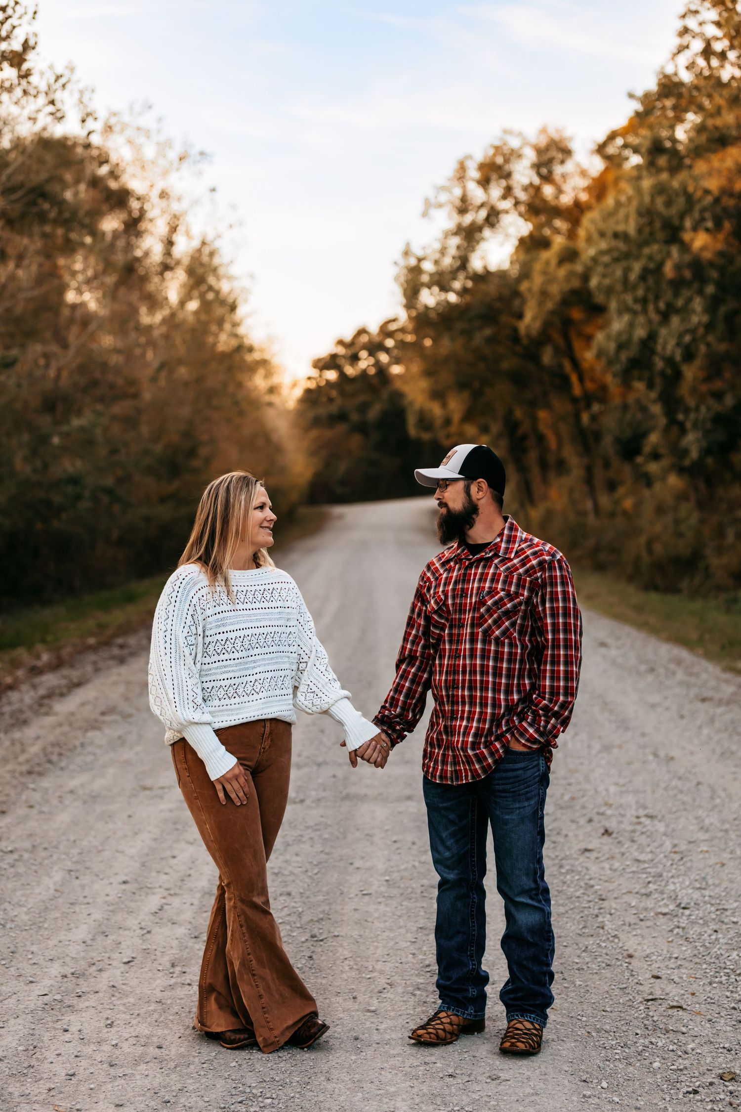 A couple on country road during golden hour in Edgerton, Missouri.