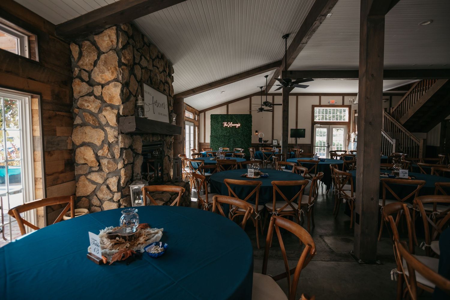 Interior of rustic venue with stone walls and wooden beams.
