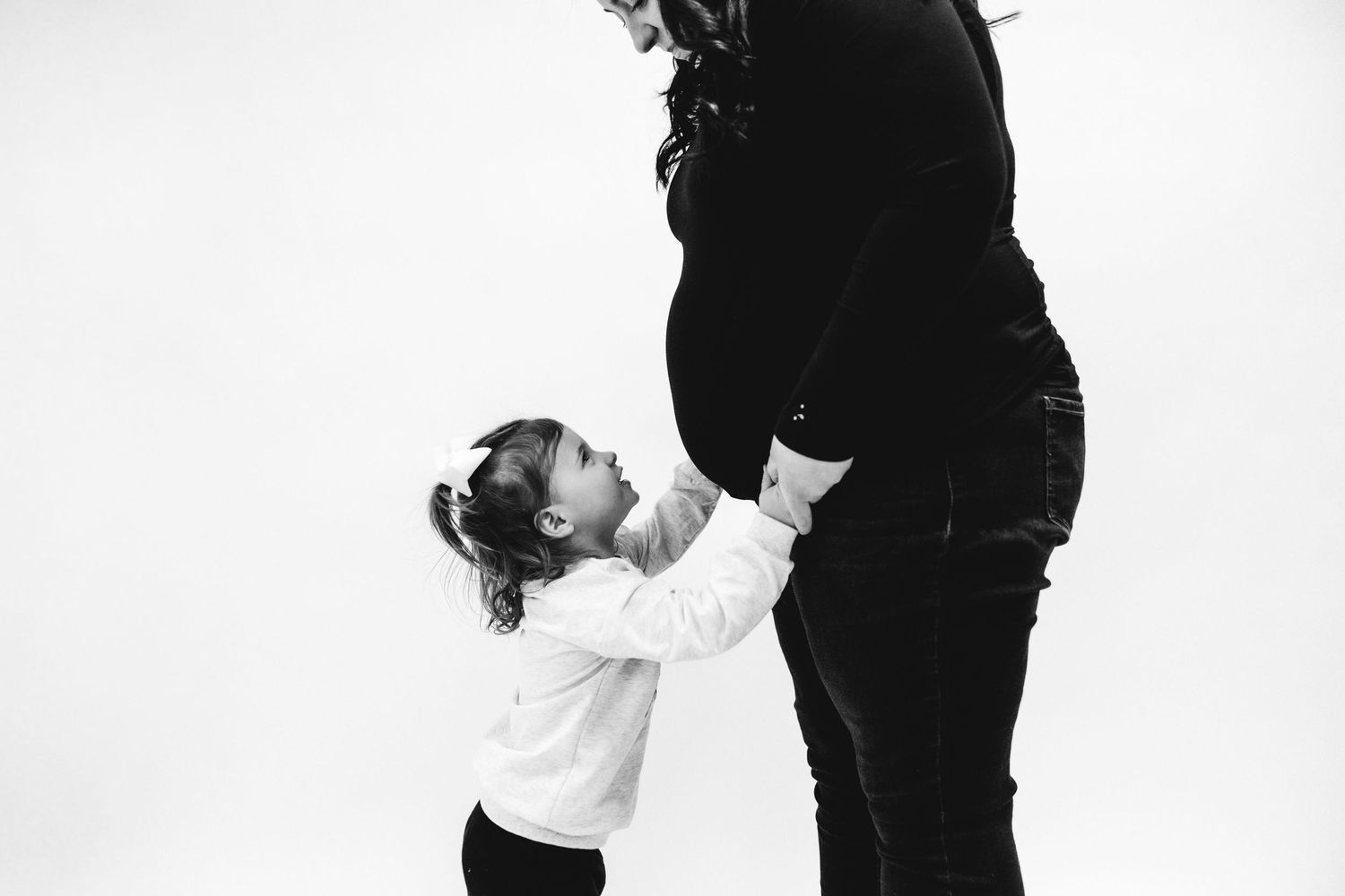 Black and white maternity photos showing mother and daughter.